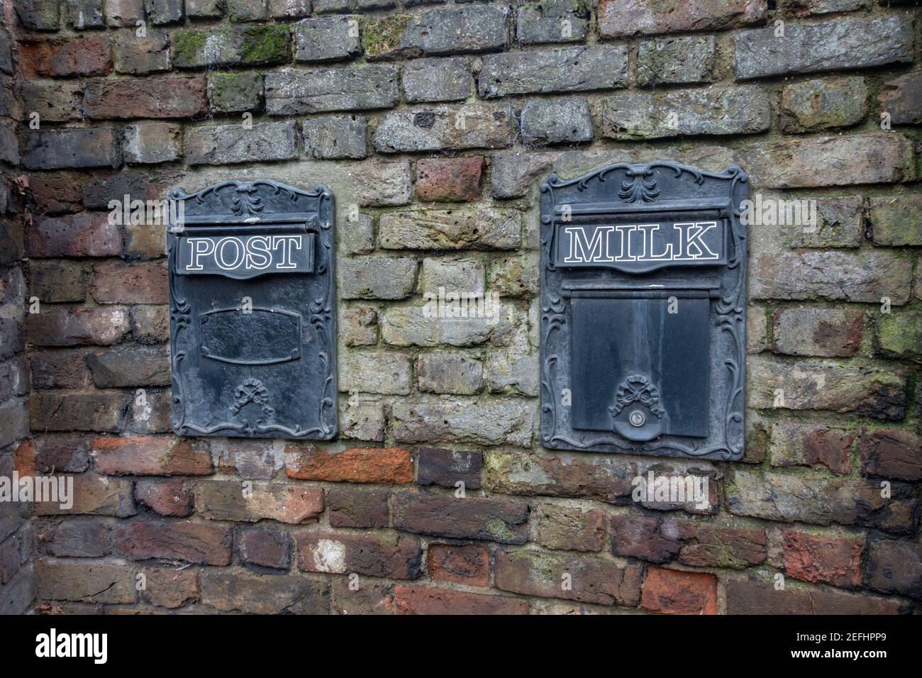 Pair of delivery boxes in a wall for post and (unusually) milk deliveries, Petersham Rd, Richmond, TW10 7AD Stock Photo