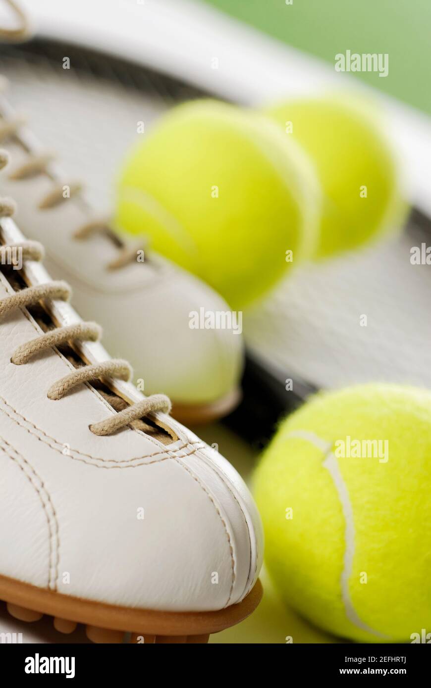 Close-up of a tennis shoe with tennis balls and a racket Stock Photo ...