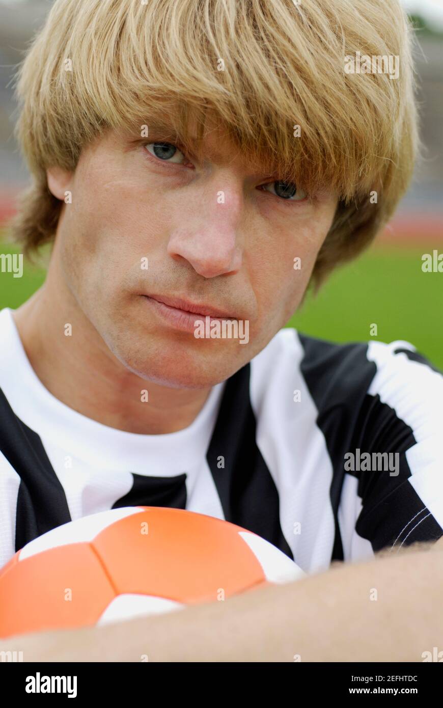 Portrait of a soccer player holding a soccer ball Stock Photo - Alamy