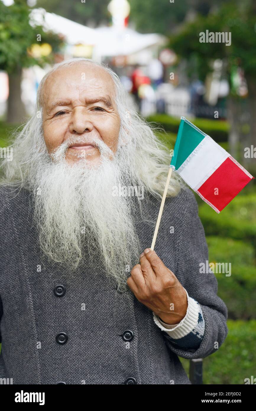 Portrait of a senior man holding a Mexican flag Stock Photo