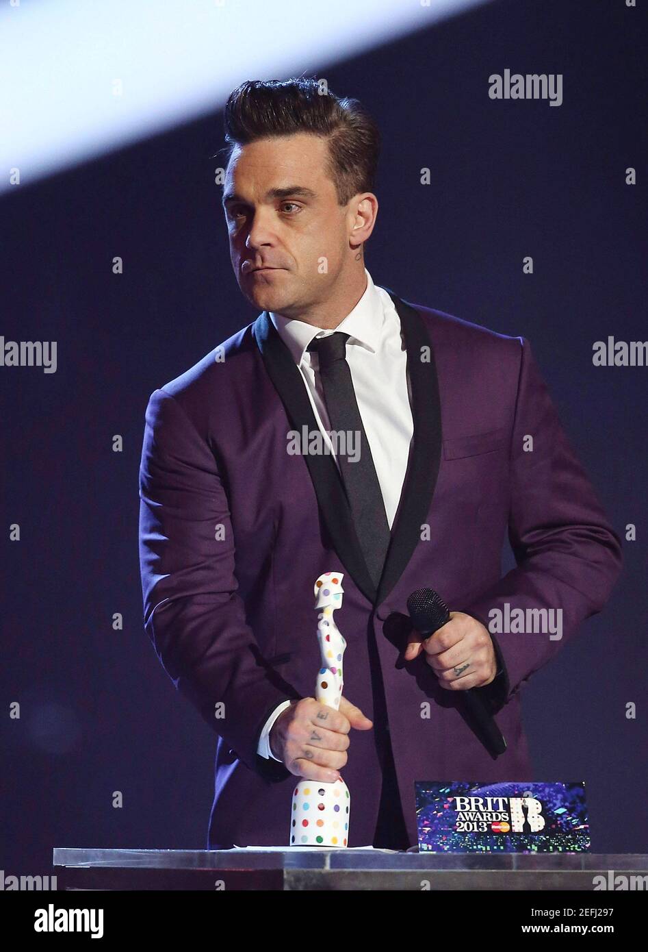 London, UK.  20th February 2013. Robbie Williams presents Award to One Direction at the 2013 Brit Awards Show, 02 Arena, London. Stock Photo
