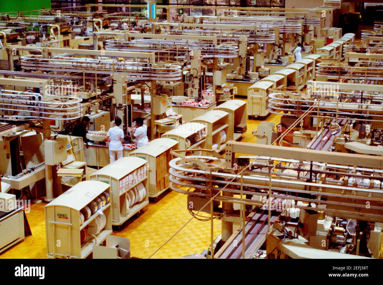 High angle view of manual workers working in a cigarette factory