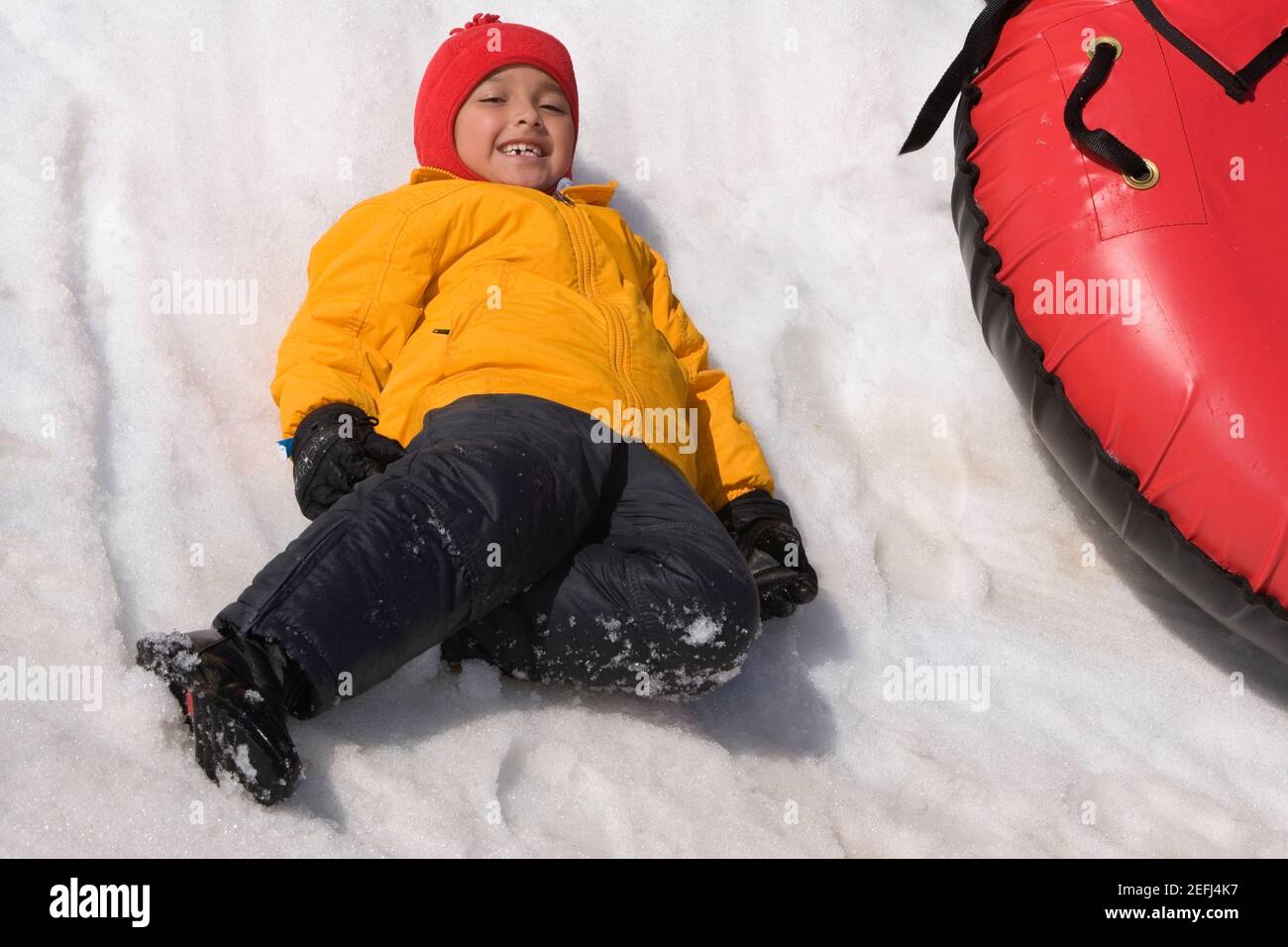 Portrait of a girl sliding with an inner tube in snow Stock Photo Alamy