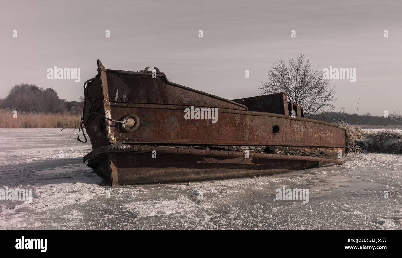 stranded ship in Brandenburg, rusty and frozen Stock Photo
