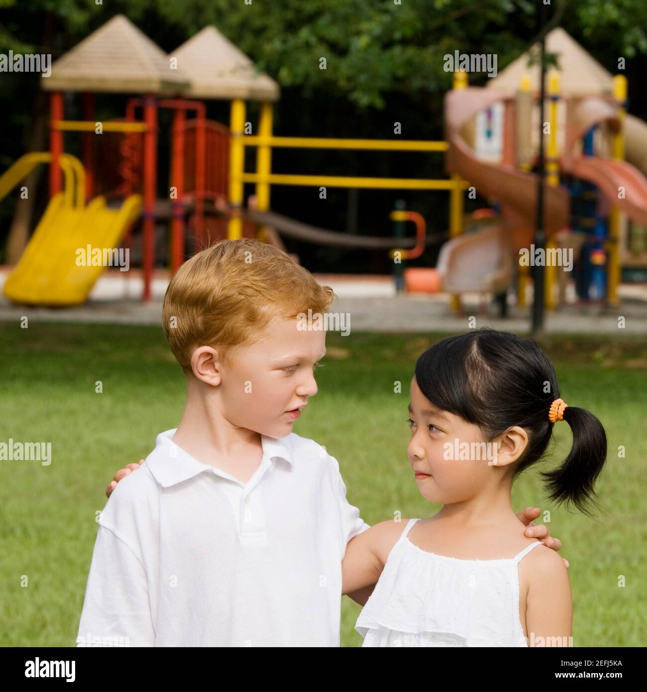 Close up of a boy and a girl looking at each other Stock Photo - Alamy