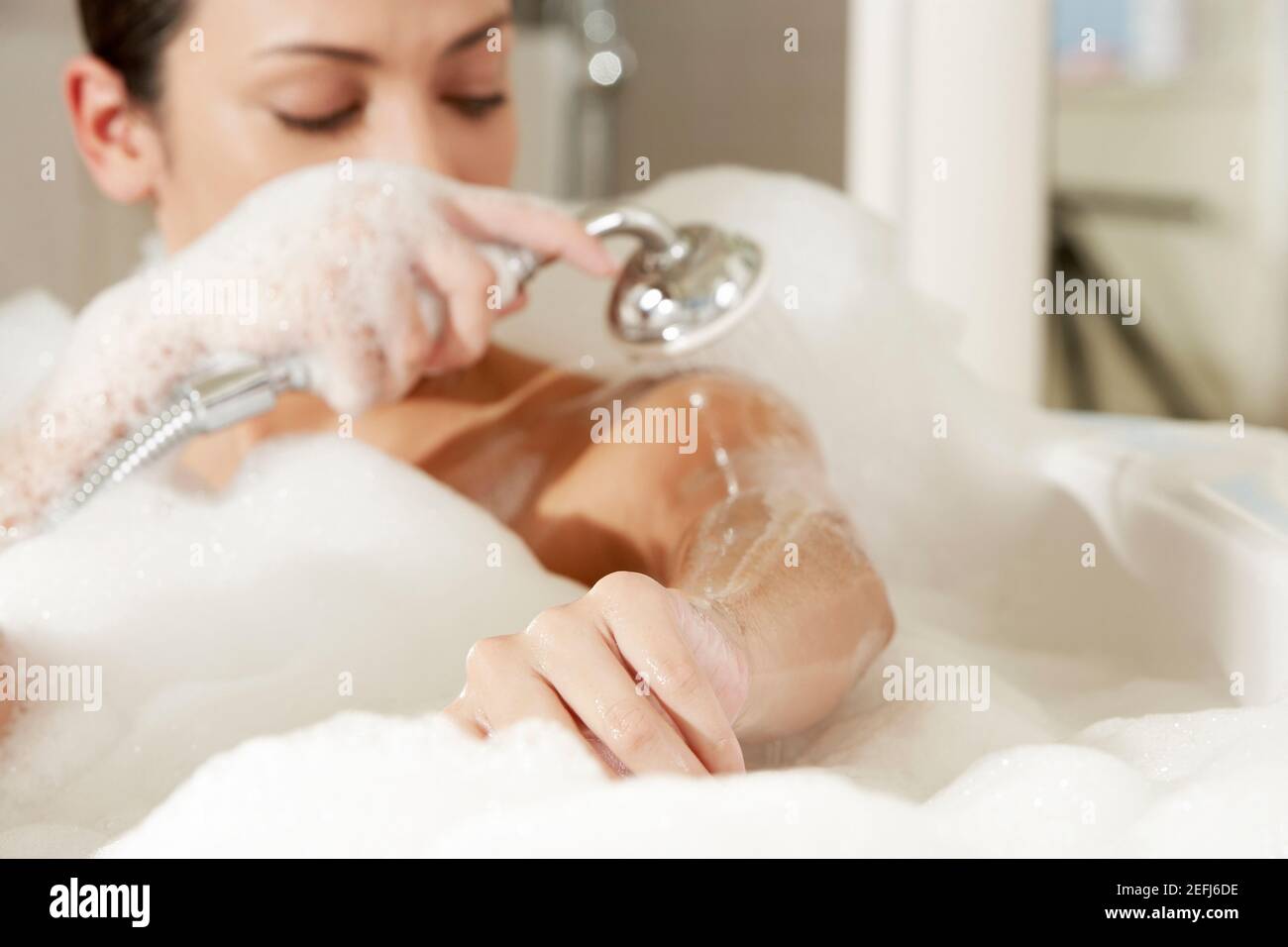 Woman taking a shower hires stock photography and images Alamy