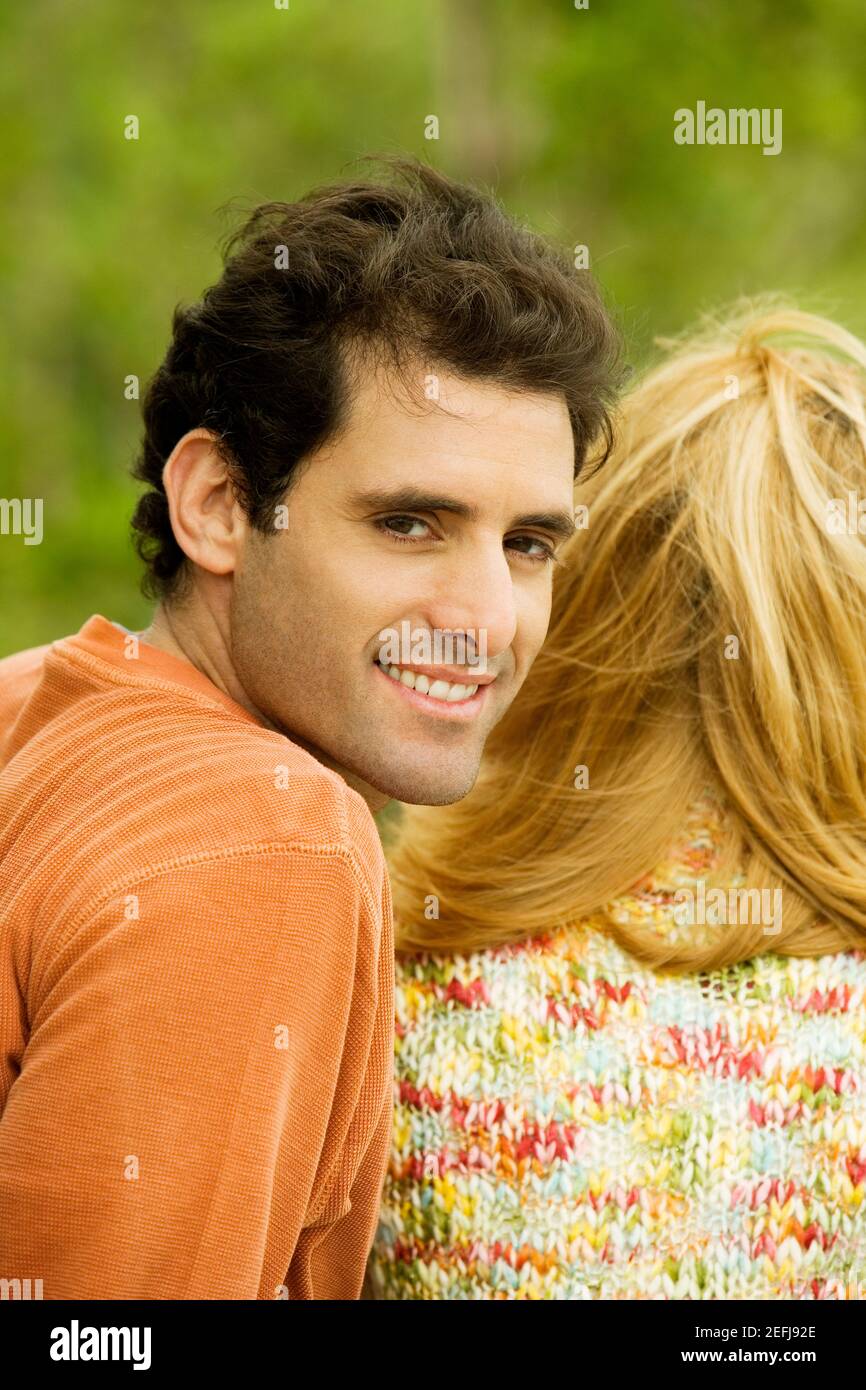 Portrait of a mid adult man sitting with a young woman Stock Photo - Alamy