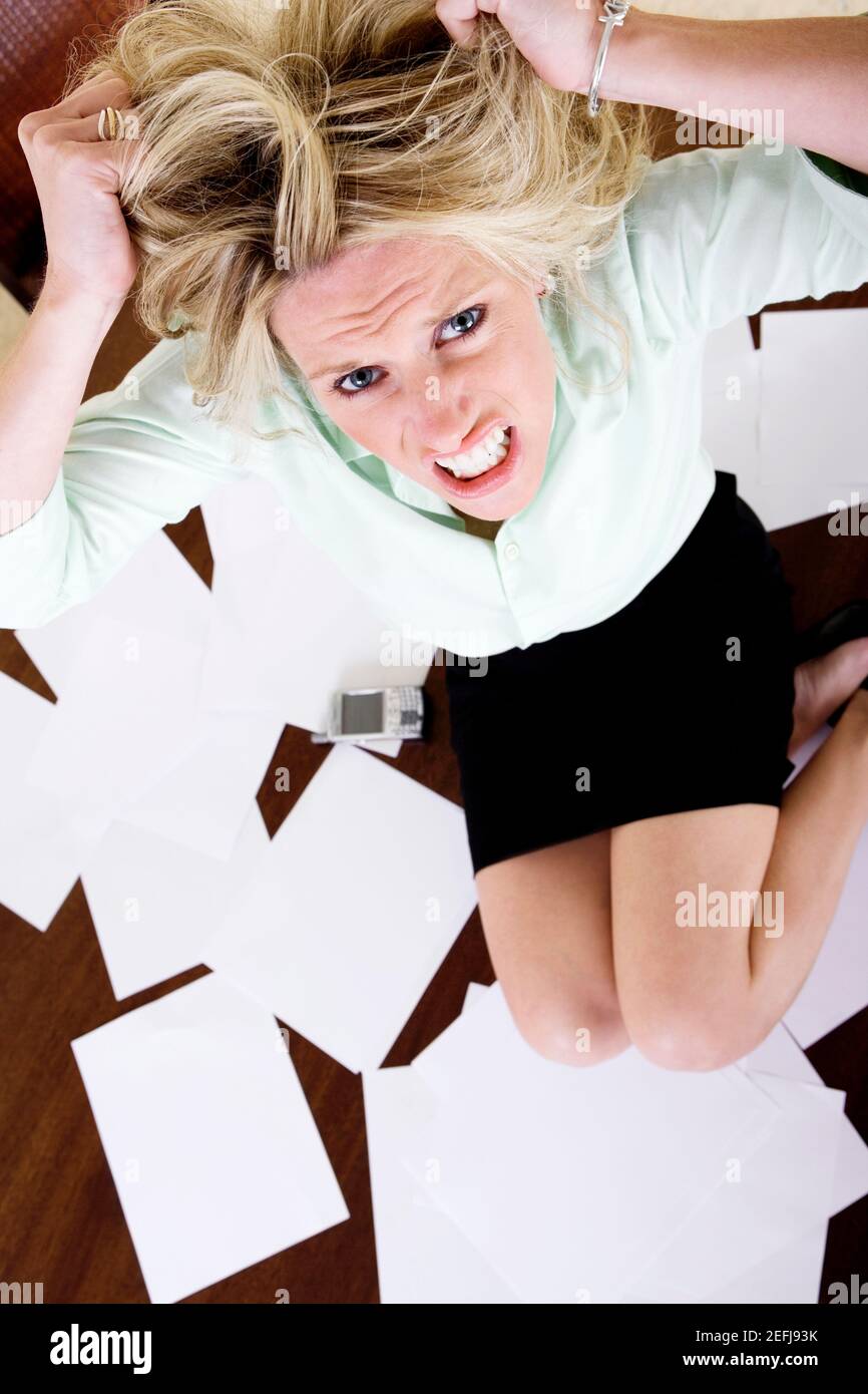 High angle view of a mid adult woman with her hands in her hair Stock Photo
