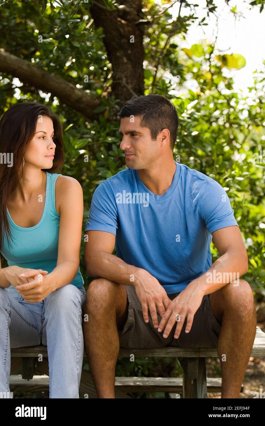 Young woman and a mid adult man looking at each other Stock Photo - Alamy