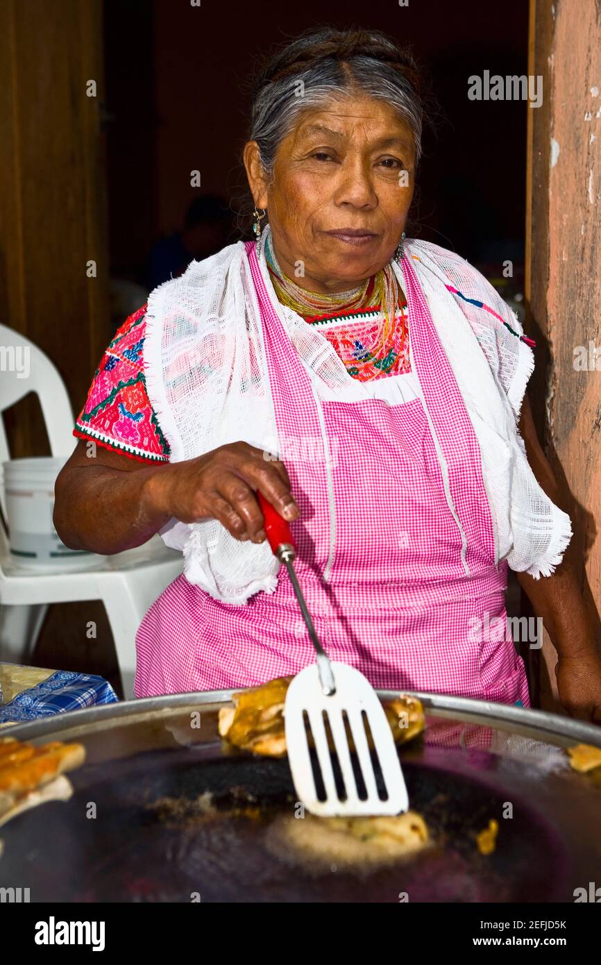 Portrait of a senior woman cooking, Cuetzalan, Puebla State, Mexico Stock Photo