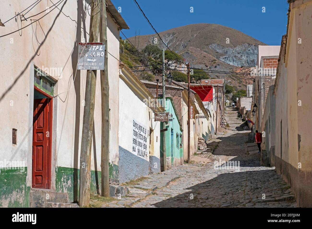 Cobbled street with adobe houses and shops the village Iruya, nestled against the mountainside in the Salta Province in northwestern Argentina Stock Photo