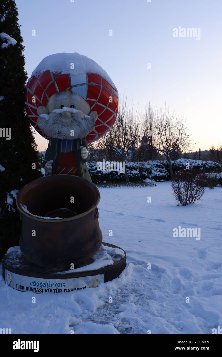 Statue of Nasreddin Hodja with a huge pan at a snowy day in winter Stock Photo