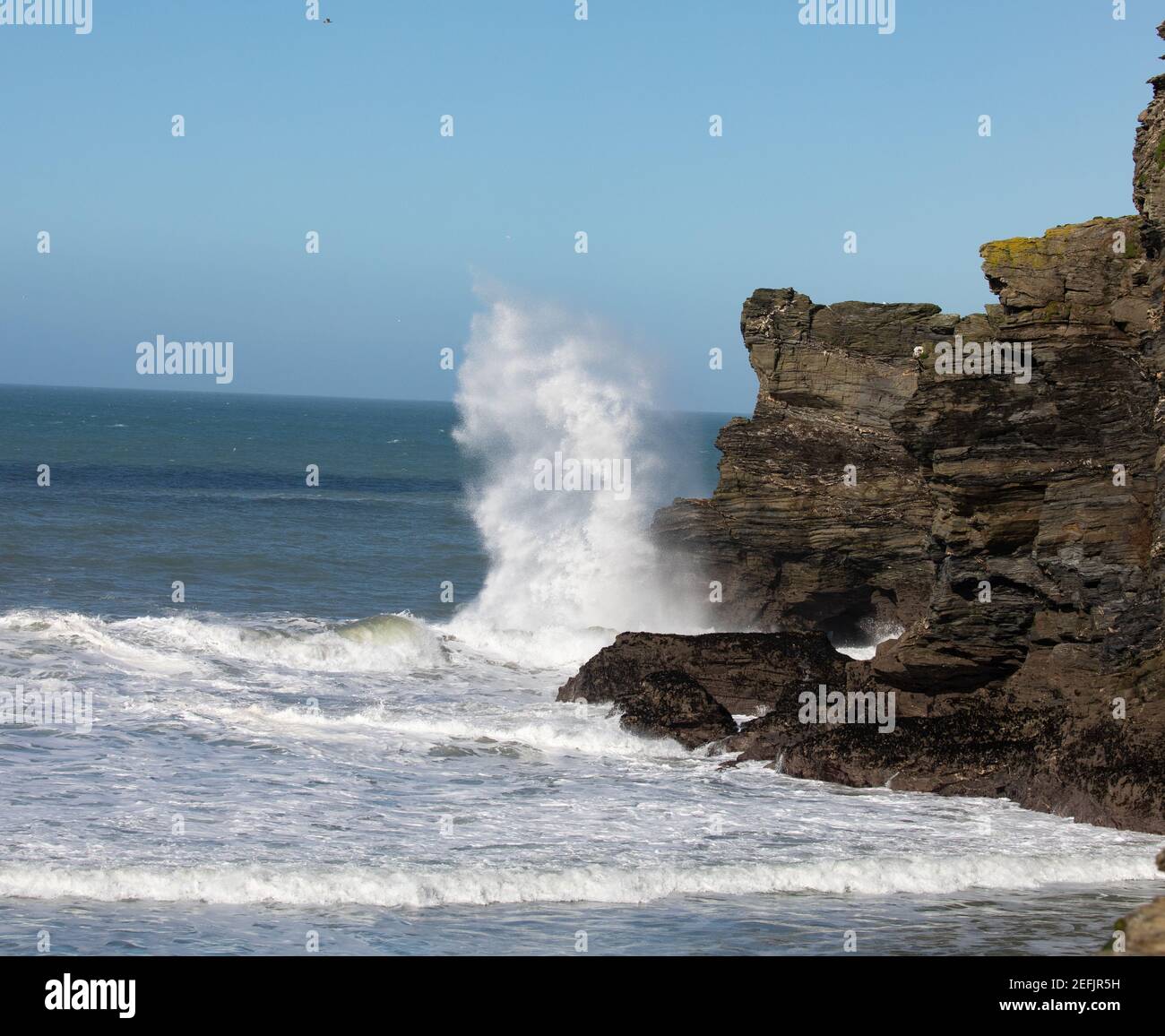 High waves caused by windy conditions hit rocks and the harbour wall in ...