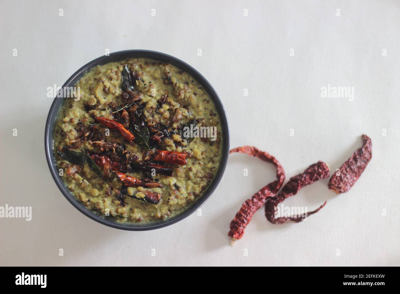 Kerala style coconut based green gram curry also called as cherupayar curry. Shot on white background Stock Photo