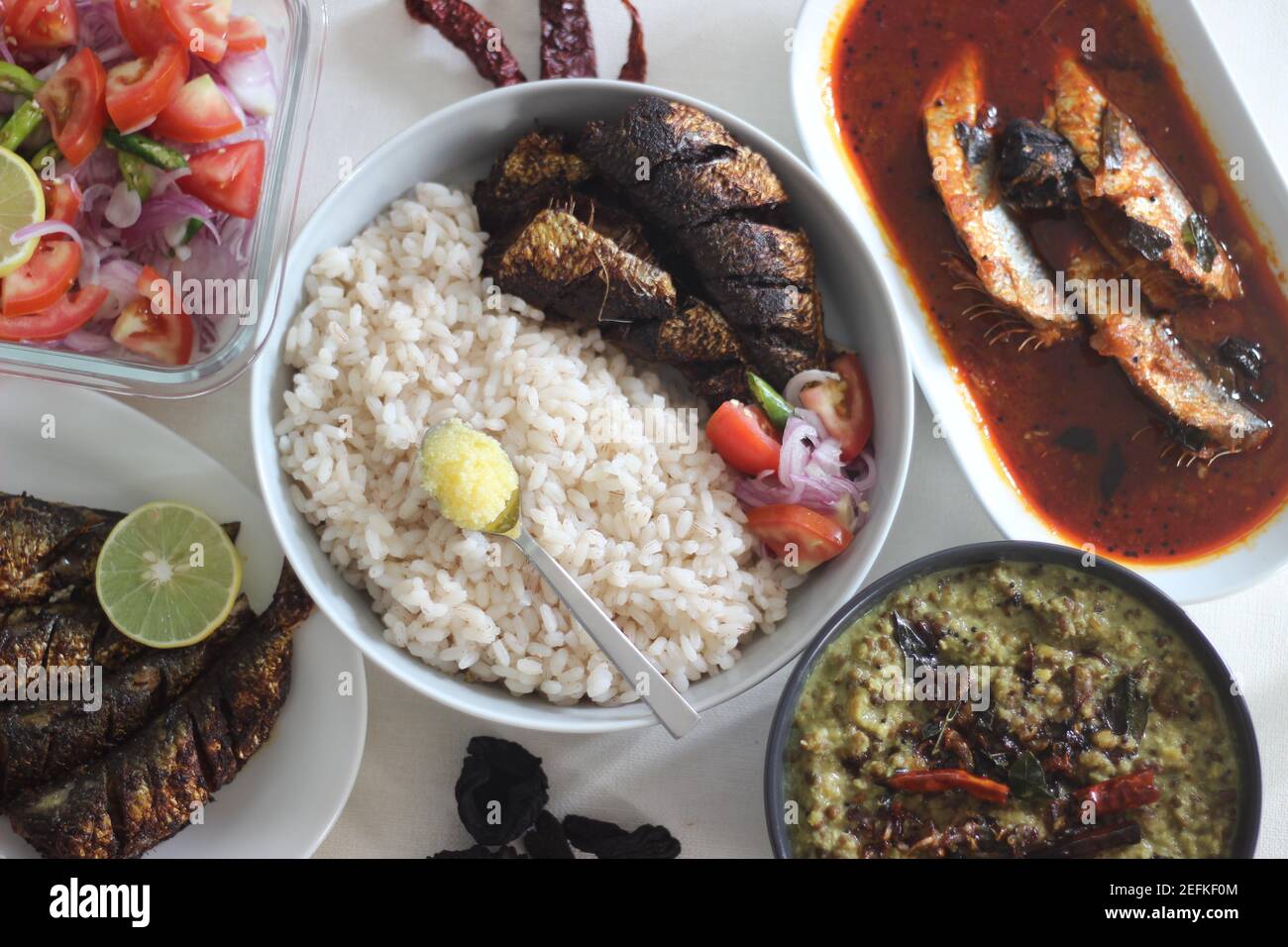 Kerala meals with red rice, sardines curry, sardine fry and coconut ...
