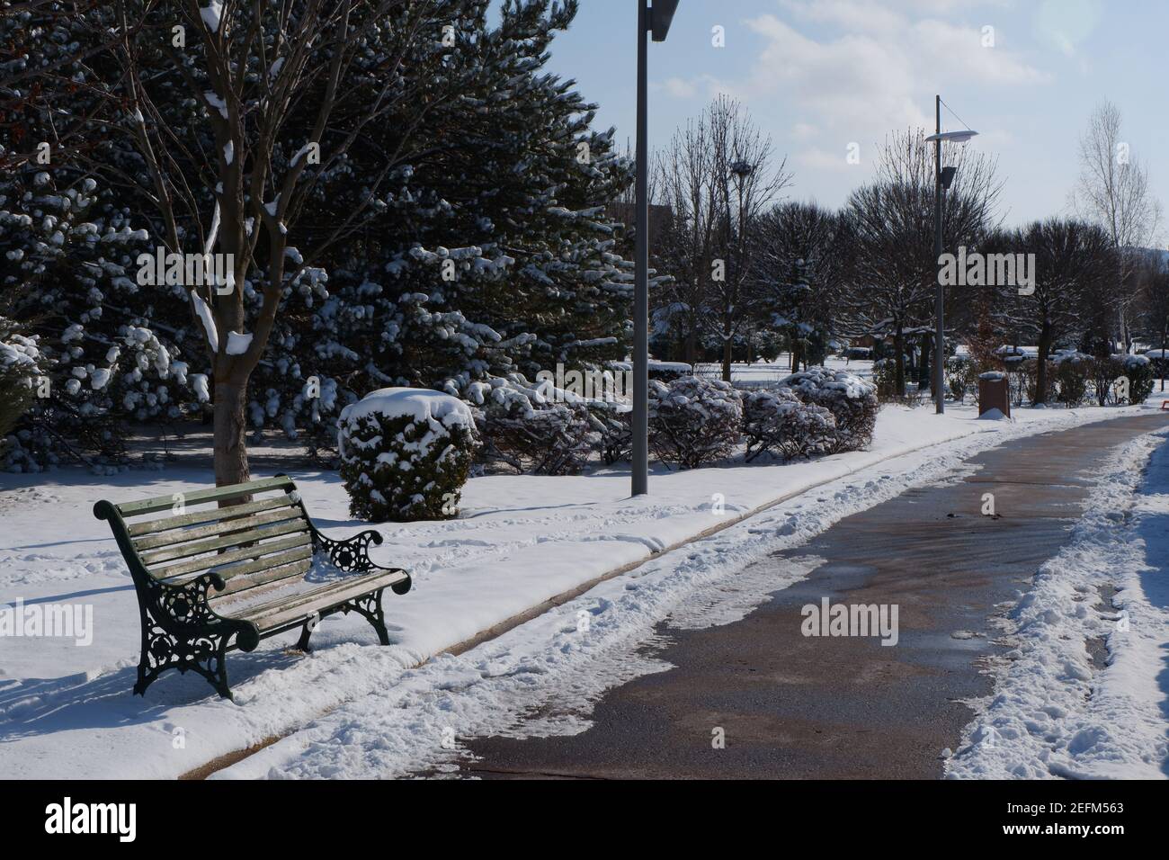 Bench at City Park under Snow Stock Photo