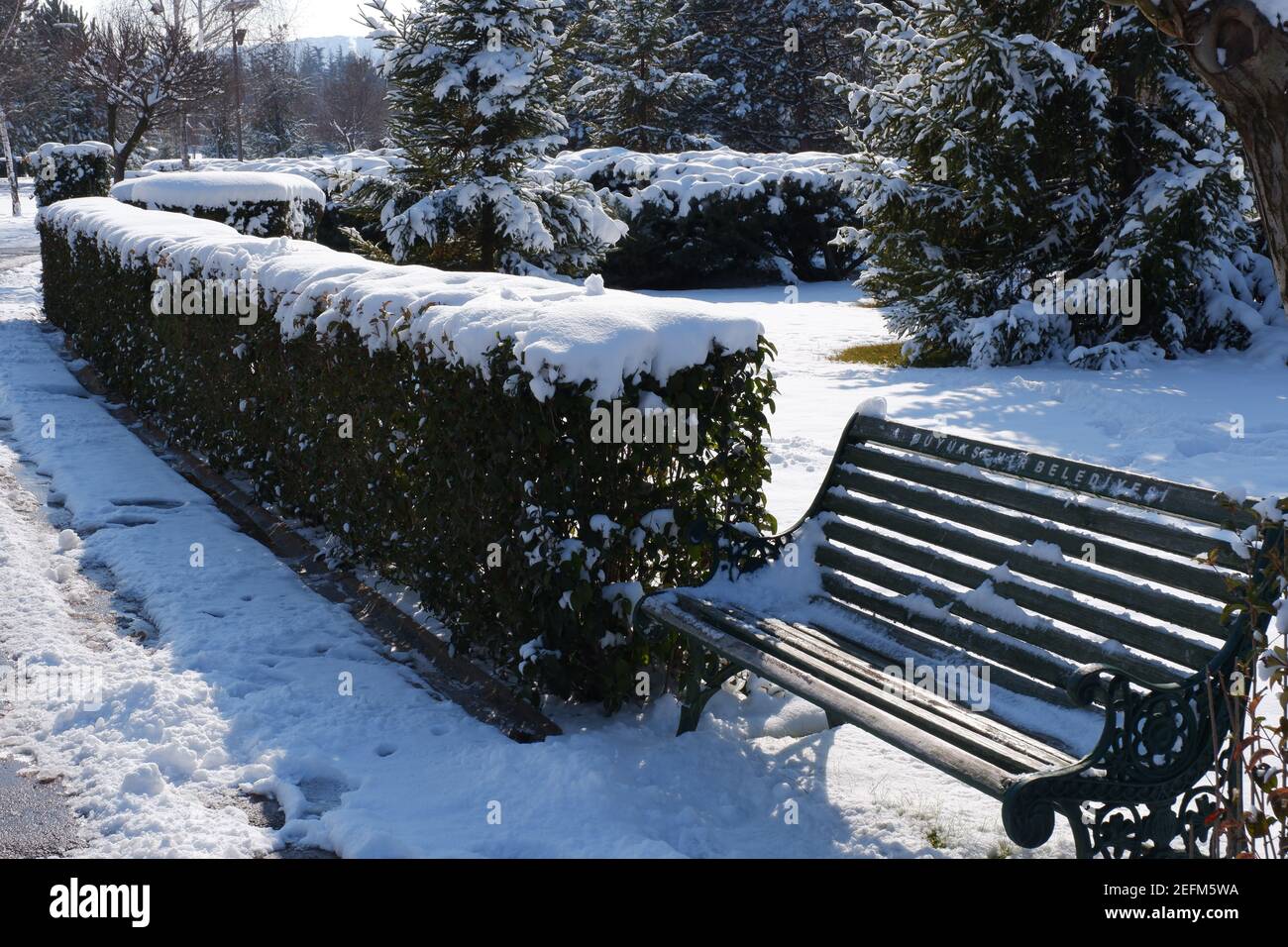 Bench at City Park under Snow Stock Photo