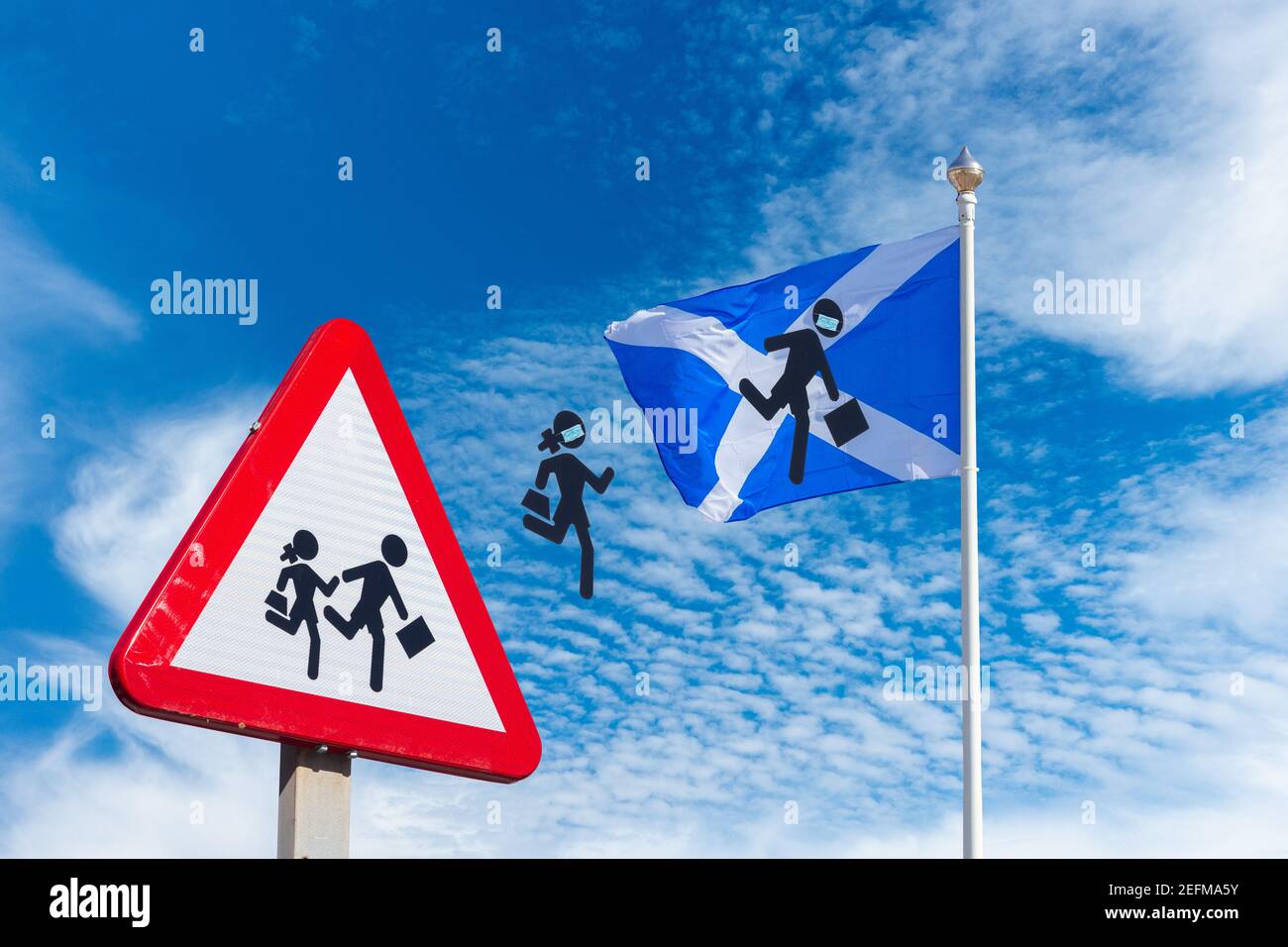 Back to school Scotland education concept: School sign and flag of Scotland against blue sky with children with face masks jumping from sign to flag. Stock Photo