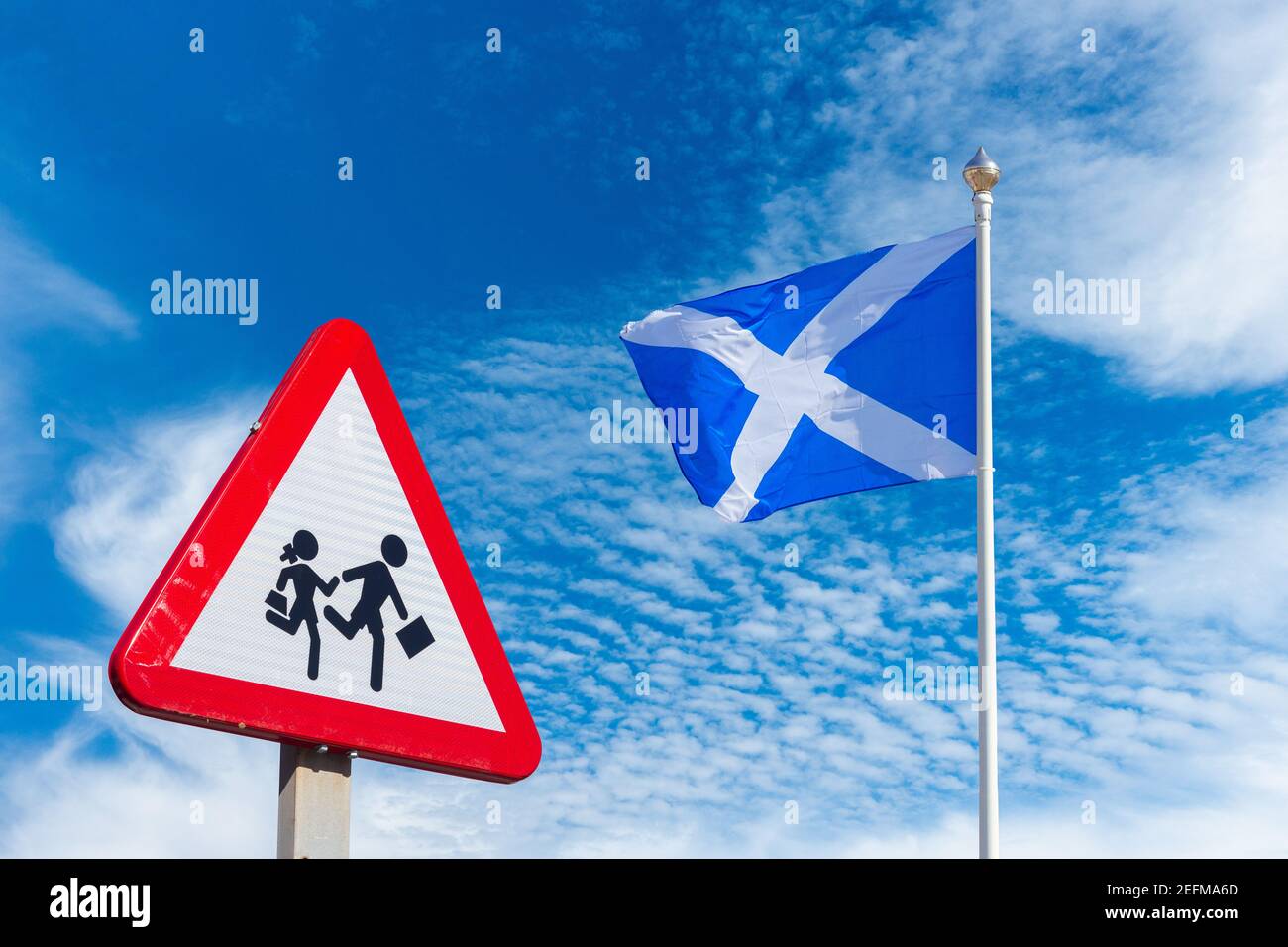 Back to school Scotland education, childcare concept: School sign and flag of Scotland against blue sky. Stock Photo