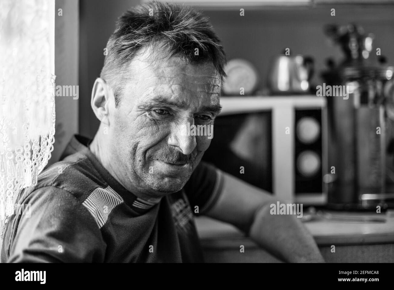A man farmer in his rural home. Black and white photo. Stock Photo