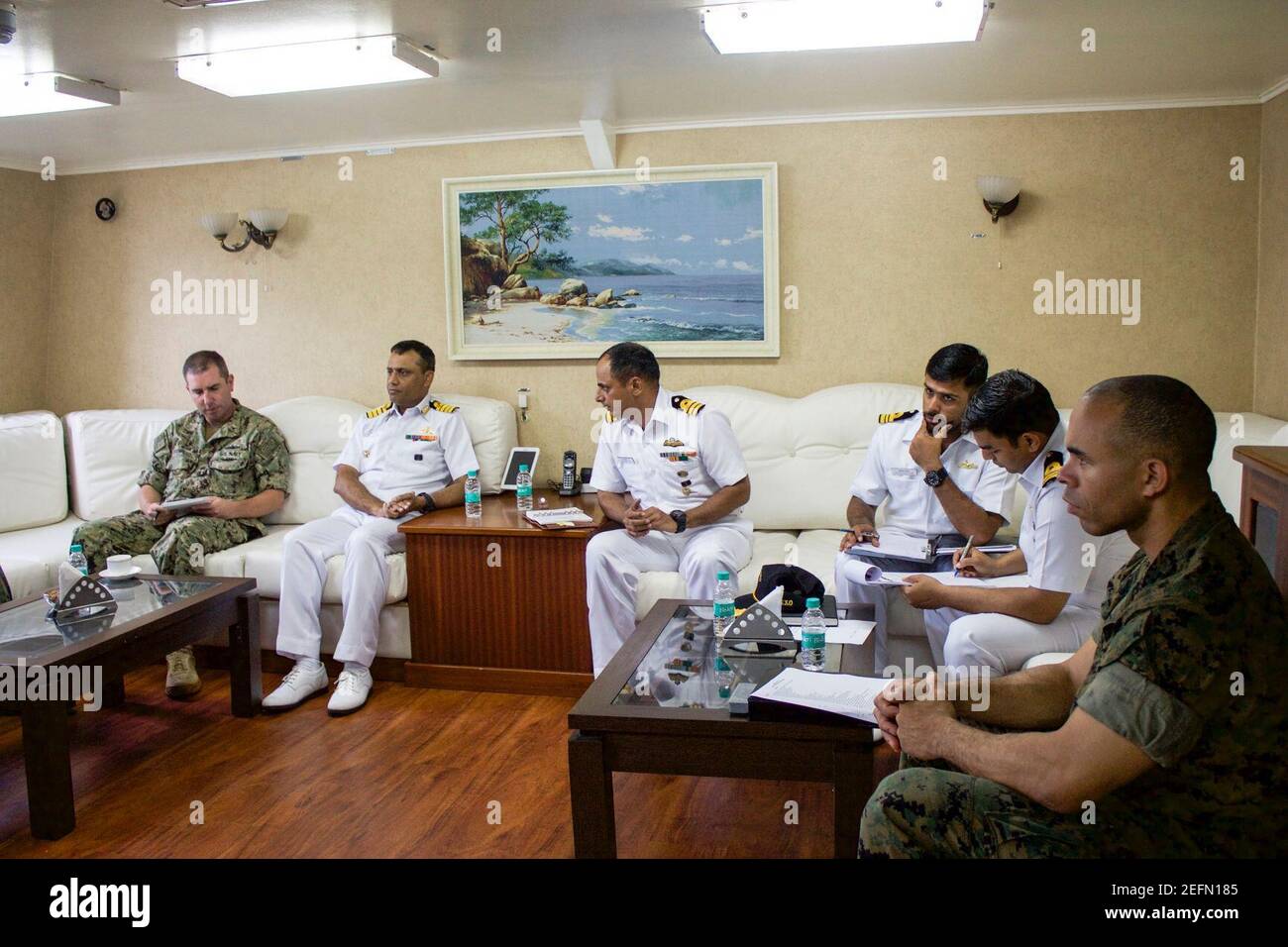 Officers from INS Trikand, the amphibious dock landing ship USS Pearl Harbor (LSD 52) and 15th Marine Expeditionary Unit (MEU) discuss plans for an upcoming passing exercise as part of a scheduled port visit. Stock Photo