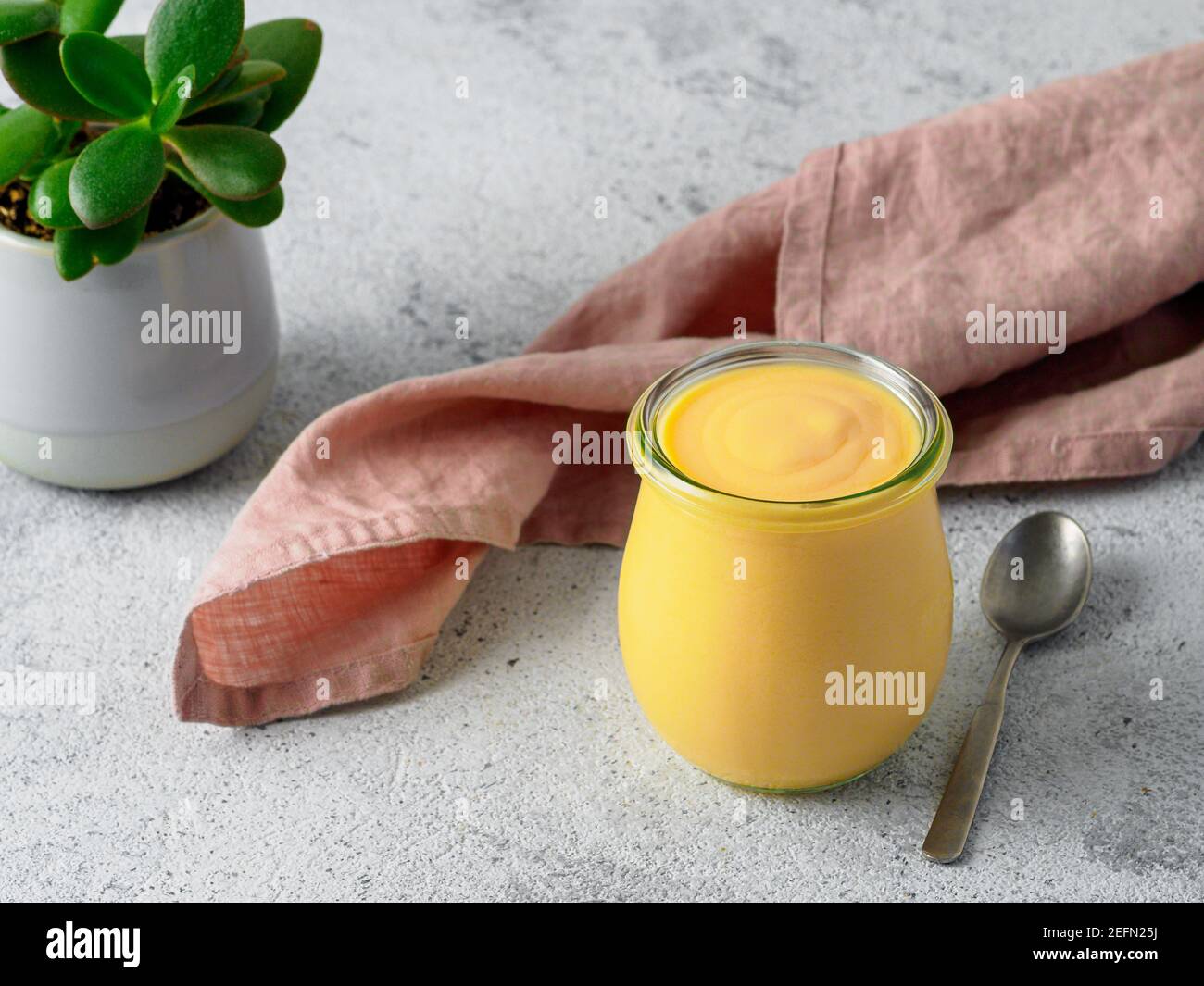 Yellow mango lassi on gray background. Indian mango yogurt drink with ...