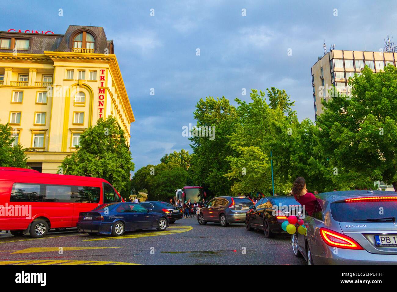 Young people school leavers dressed in elegant ballgown and costumes coming with cars to the restaurant for thair prom day party,Plovdiv,Bulgaria Stock Photo