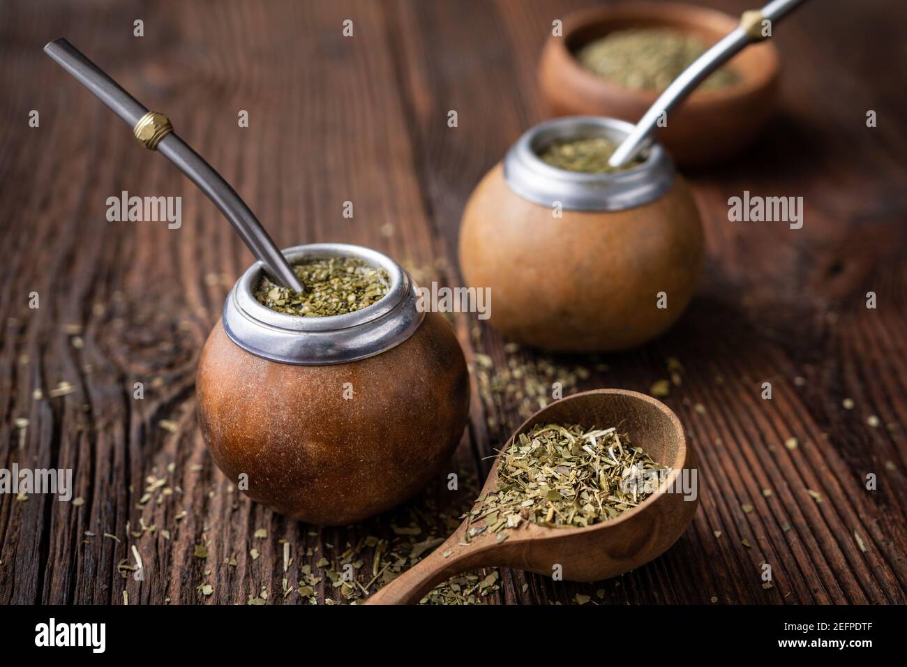 Healthy infused drink, classic Yerba Mate tea in a gourd with mobilla on wooden background Stock Photo