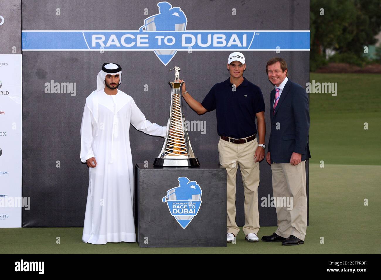 Golf - Dubai World Championship - Jumeirah Golf Estates, Dubai, United Arab  Emirates - 28/11/10 Germany's Martin Kaymer (C) is presented with the Race  To Dubai trophy by the Chairman of the