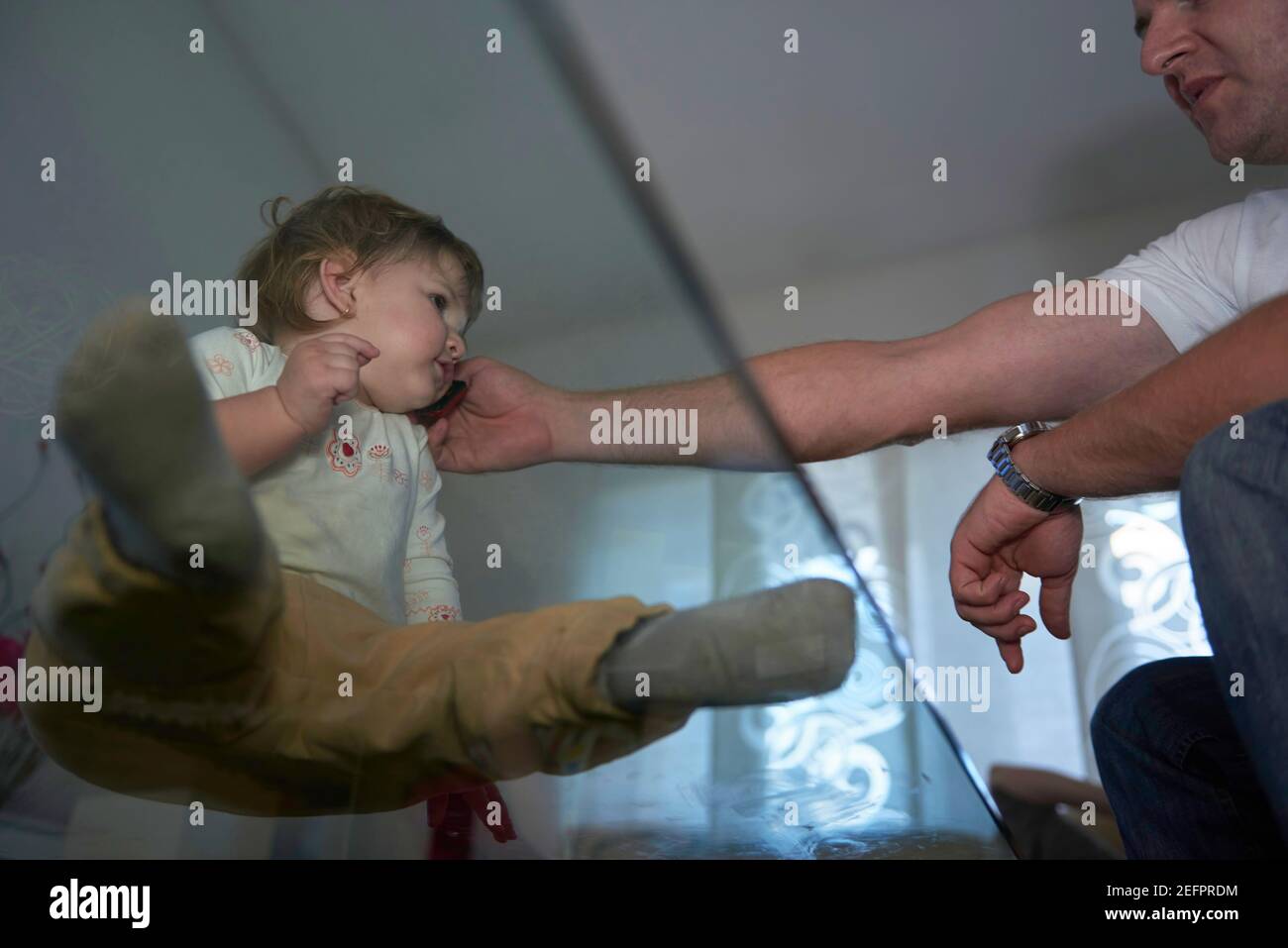 Little child playing with sister at home Stock Photo Alamy