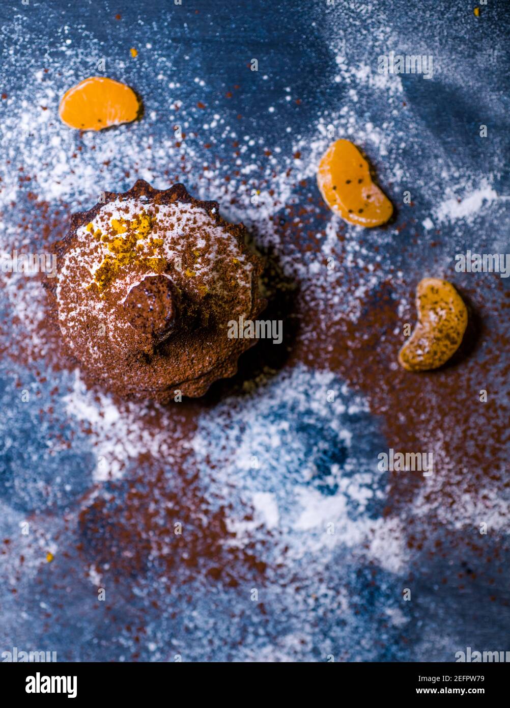 chocolate muffins sprinkled with goodies with cherries and chocolate and cocoa Stock Photo