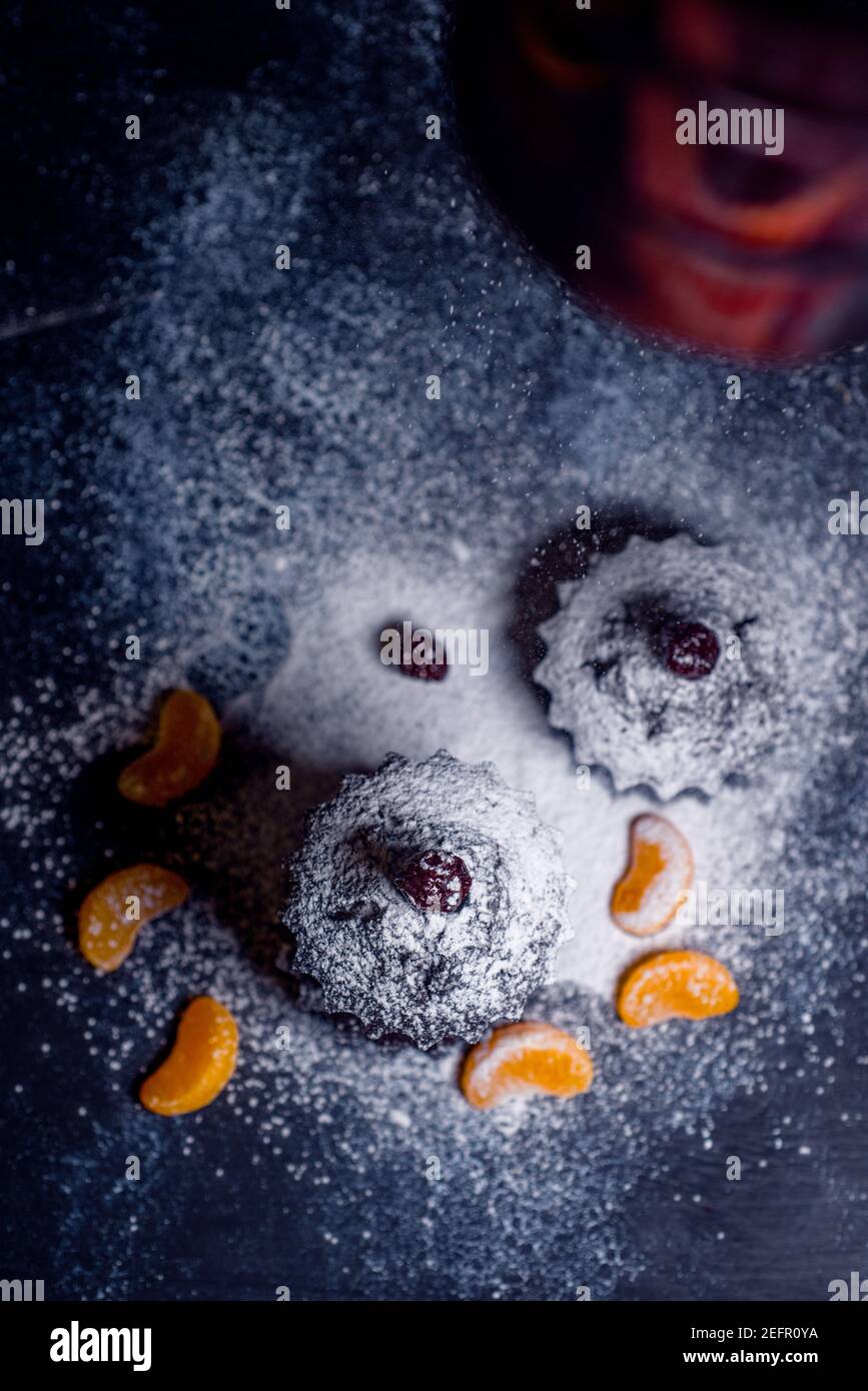 chocolate muffins sprinkled with goodies with cherries and chocolate and cocoa Stock Photo