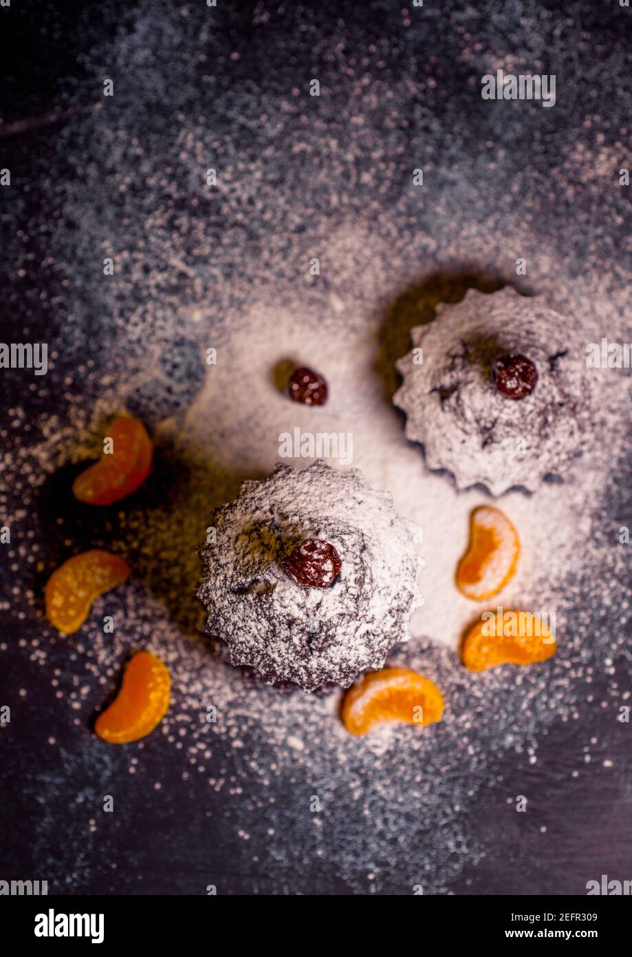 chocolate muffins sprinkled with goodies with cherries and chocolate and cocoa Stock Photo
