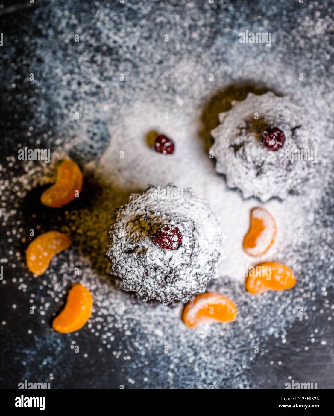 chocolate muffins sprinkled with goodies with cherries and chocolate and cocoa Stock Photo