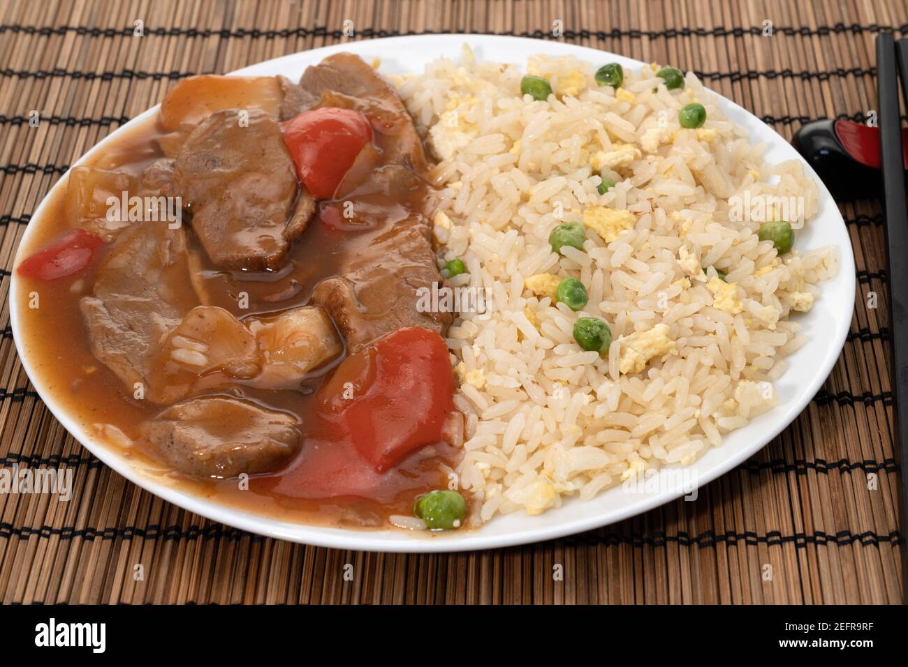 Sliced duck in a rich plum sauce seved with egg and fried rice Stock Photo
