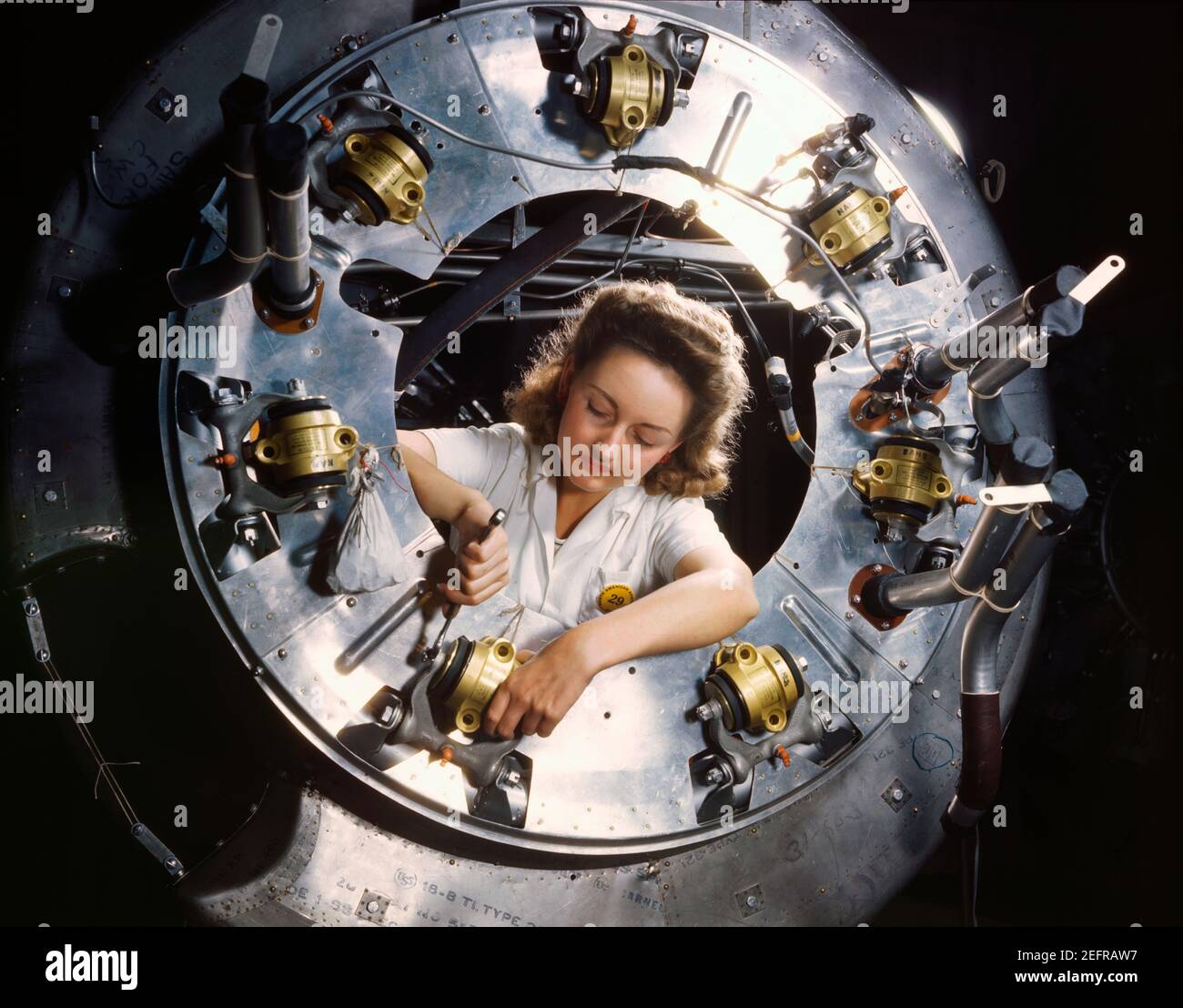 Part of the cowling for one of the motors for a B-25 bomber is assembled in the engine department of North American Aviation, Inc's Inglewood, California plant. October 1942 Stock Photo