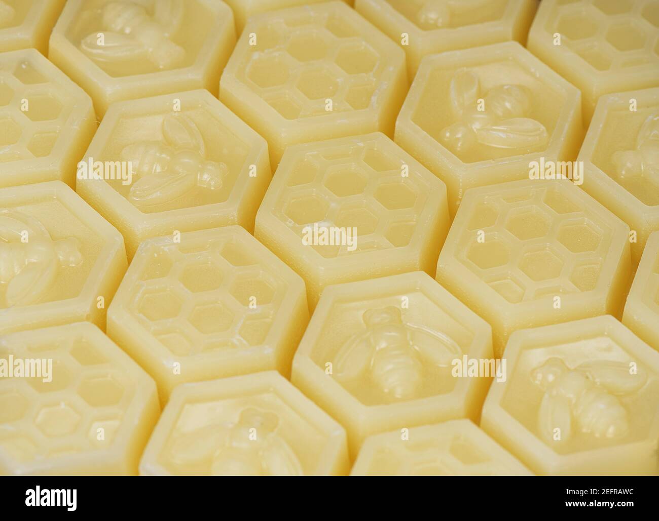 Natural Beeswax, Cera Alba, Bees Wax product in hexagon shaped clusters. Closeup background texture. Stock Photo
