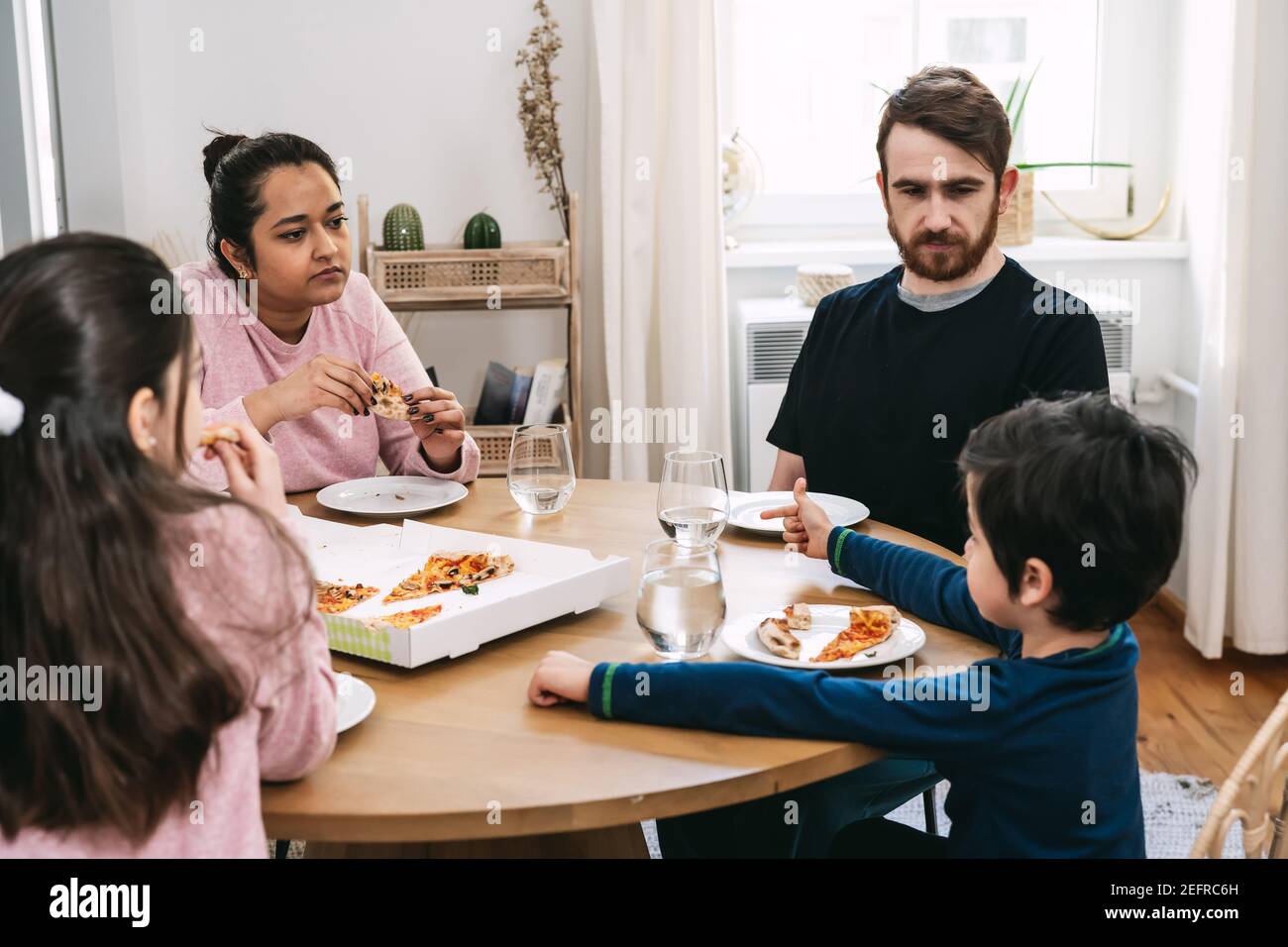 Multinational family eating lunch at home Stock Photo