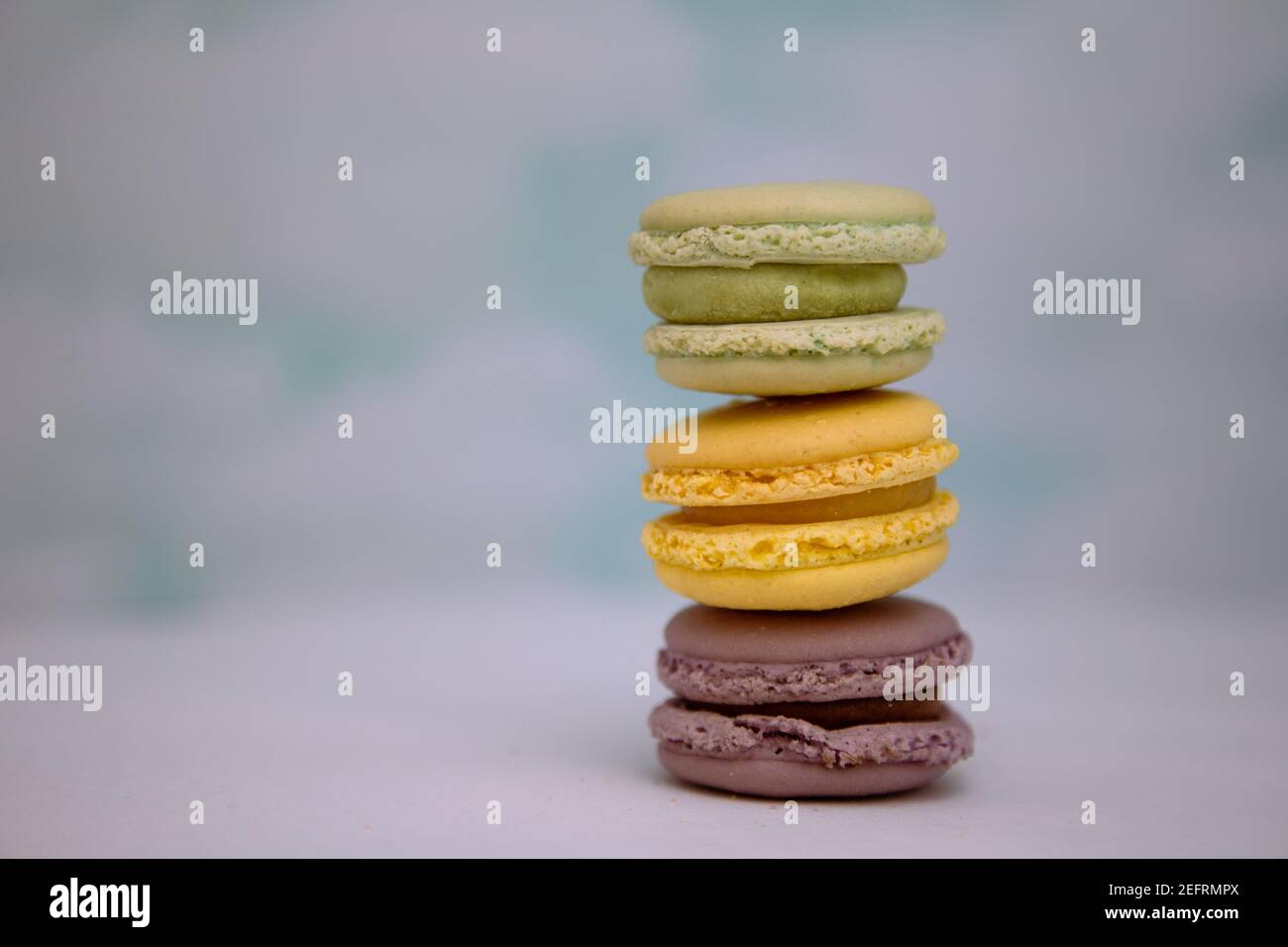 Three macarons stacked up in front of a cloud background Stock Photo ...