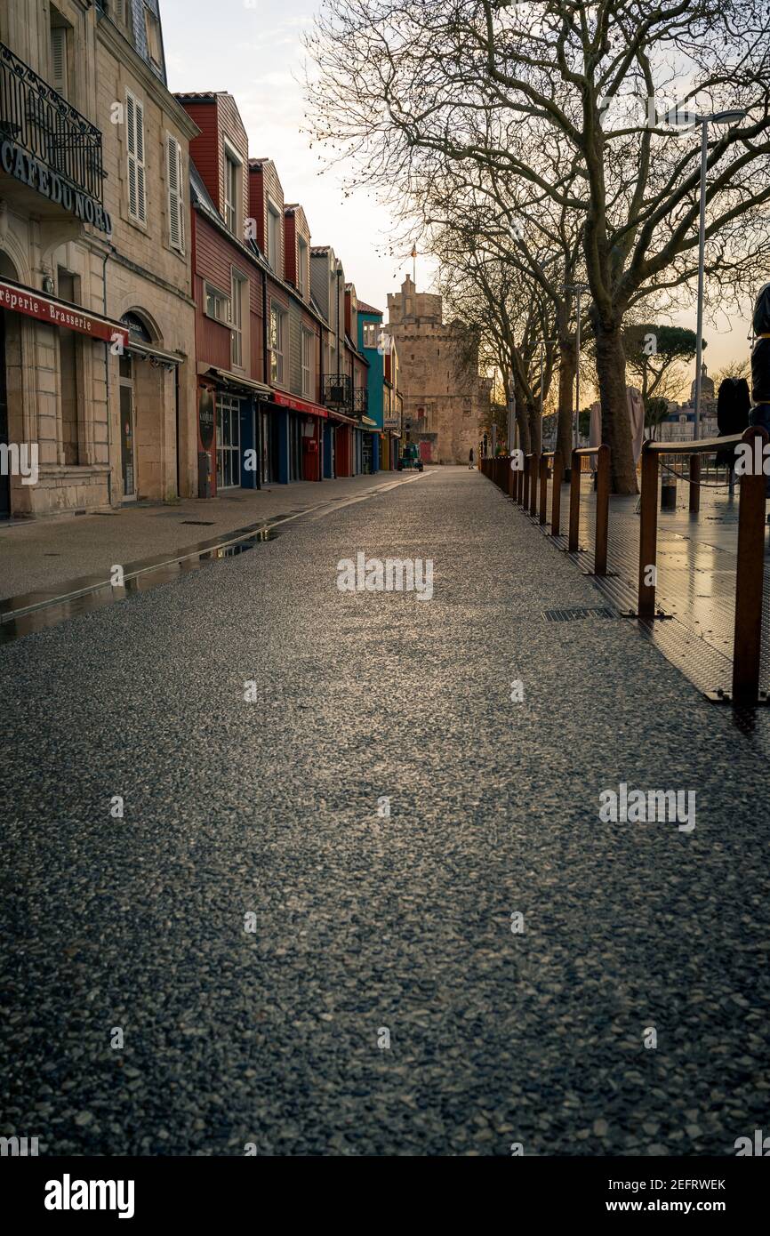 empty street at evening in La rochelle, France. Saint Nicolas Tower in the background Stock Photo