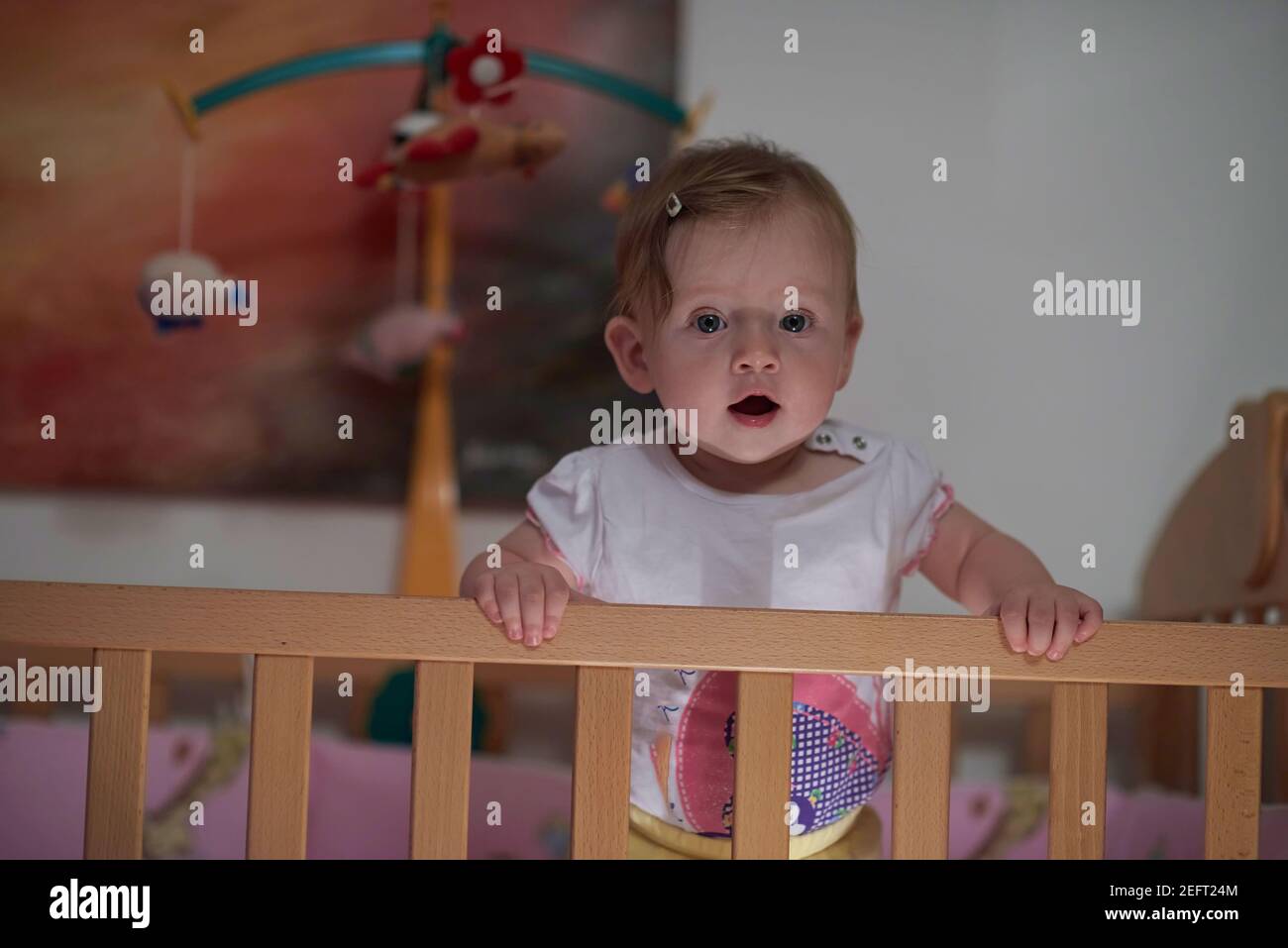 cute little one year old baby and making first steps in bed Stock Photo