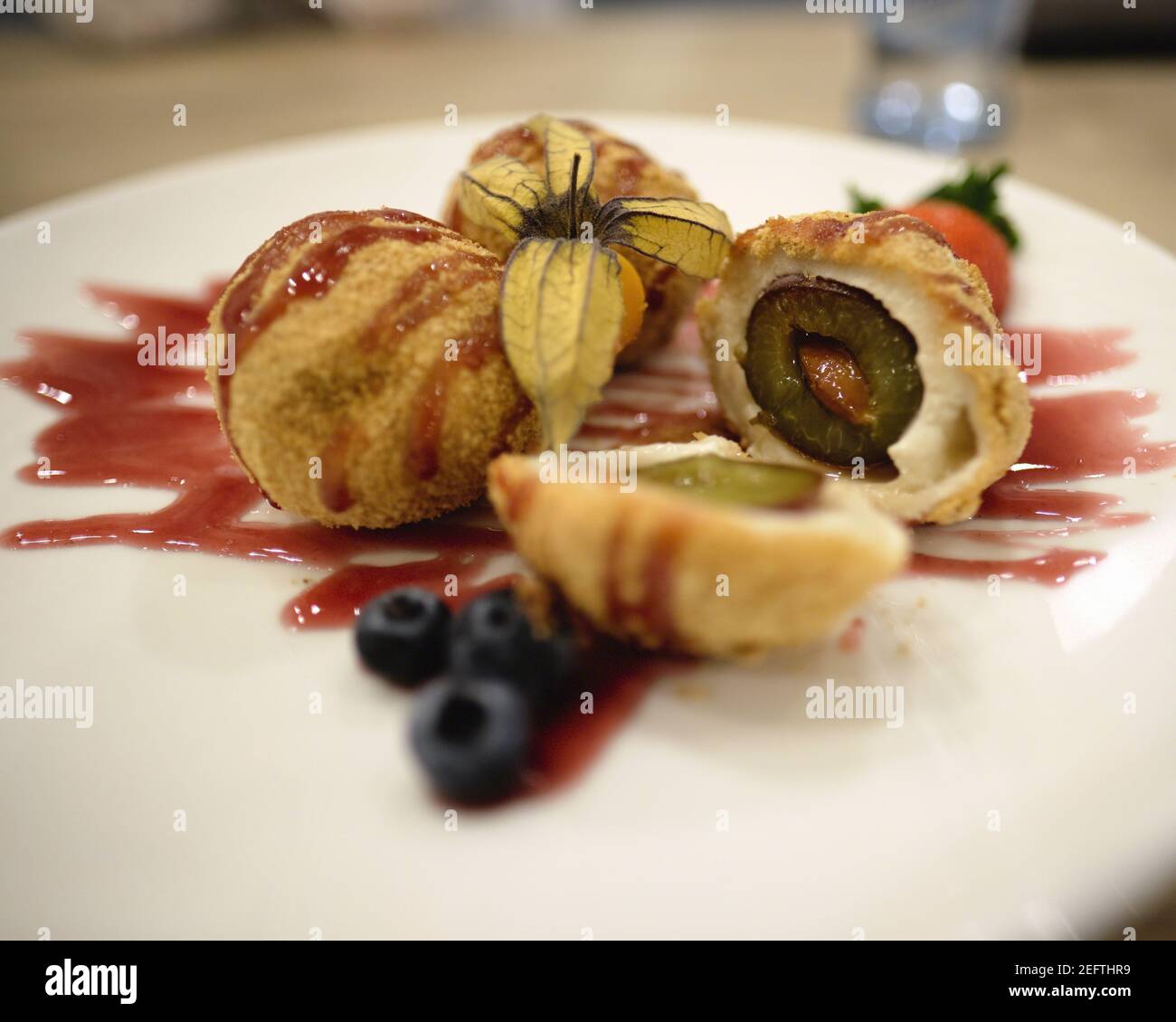 Hungarian Toasted Bread Crumb and Cinnamon Sugar Coated Dumplings Filled With Italian Plums Stock Photo