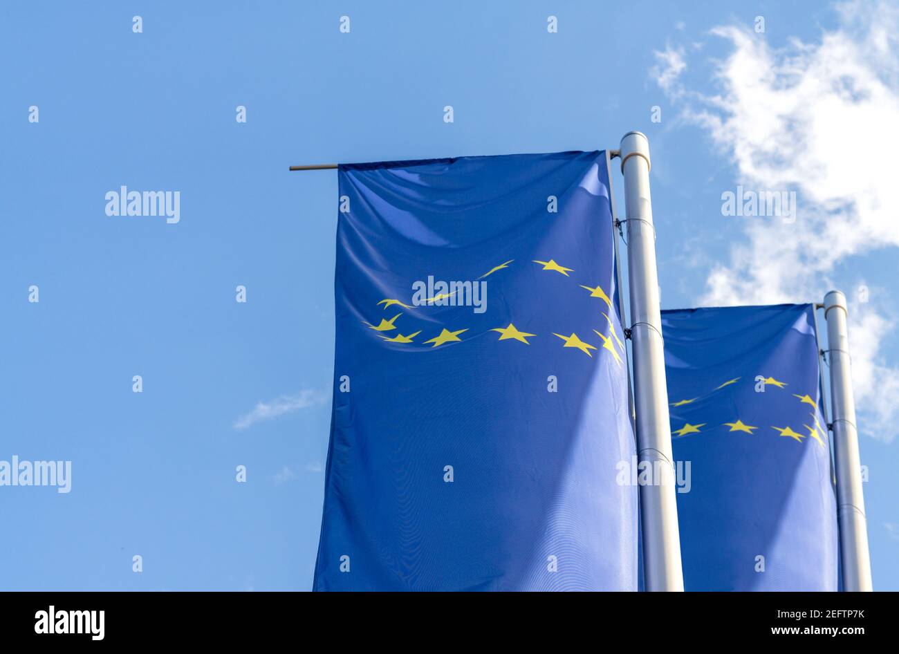 Flags of the European Union on poles against blue sky Stock Photo - Alamy
