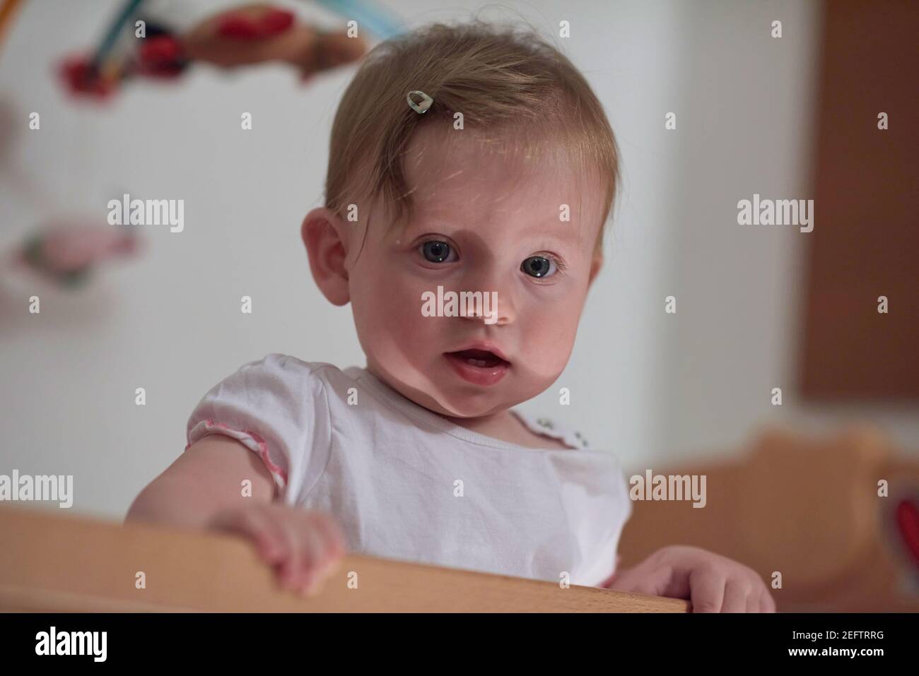 cute little one year old baby and making first steps in bed Stock Photo