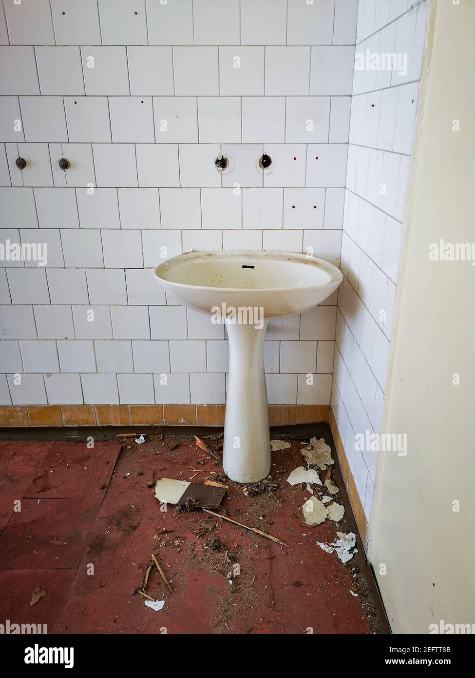 Old sink against the wall in old abandoned hospital Stock Photo Alamy