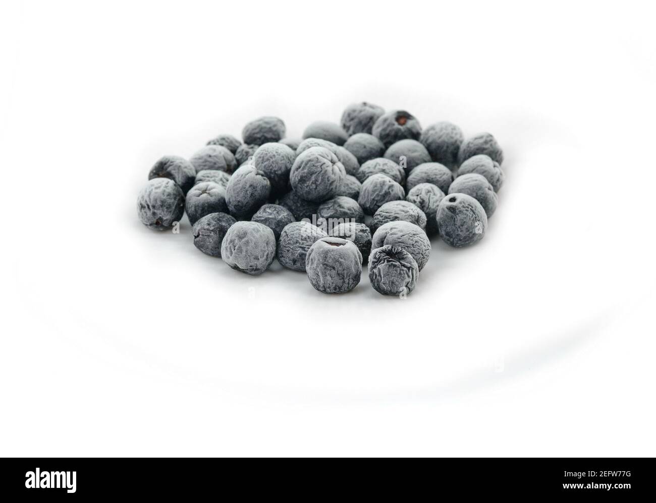 Organic frozen aronia berries on white background Stock Photo - Alamy