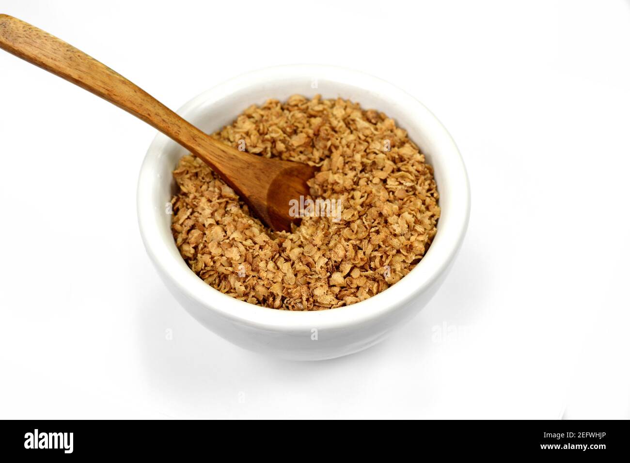 Buckwheat flakes in a bowl isolated on white background. Healthy