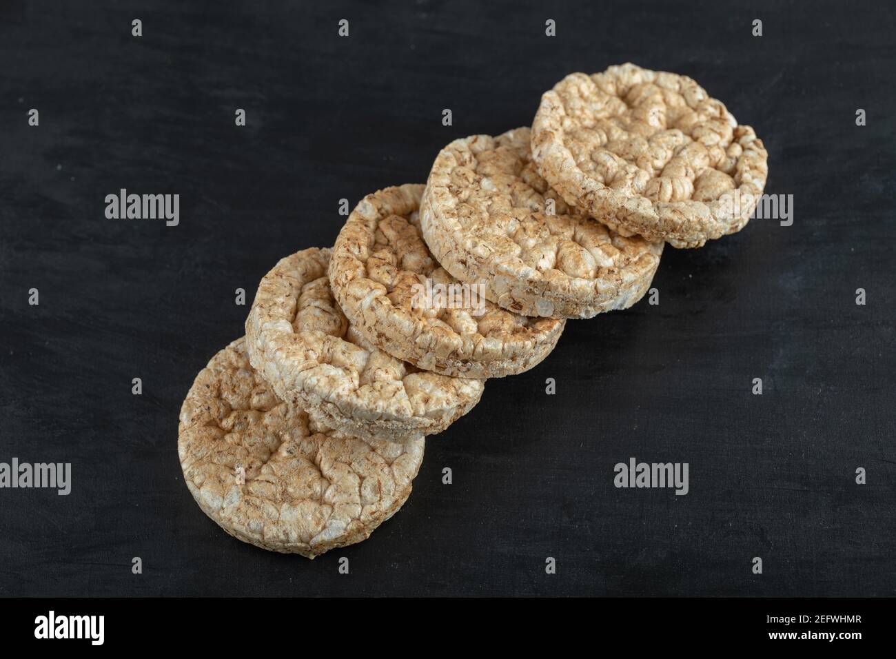 Pile of crispy rice cakes on black background Stock Photo