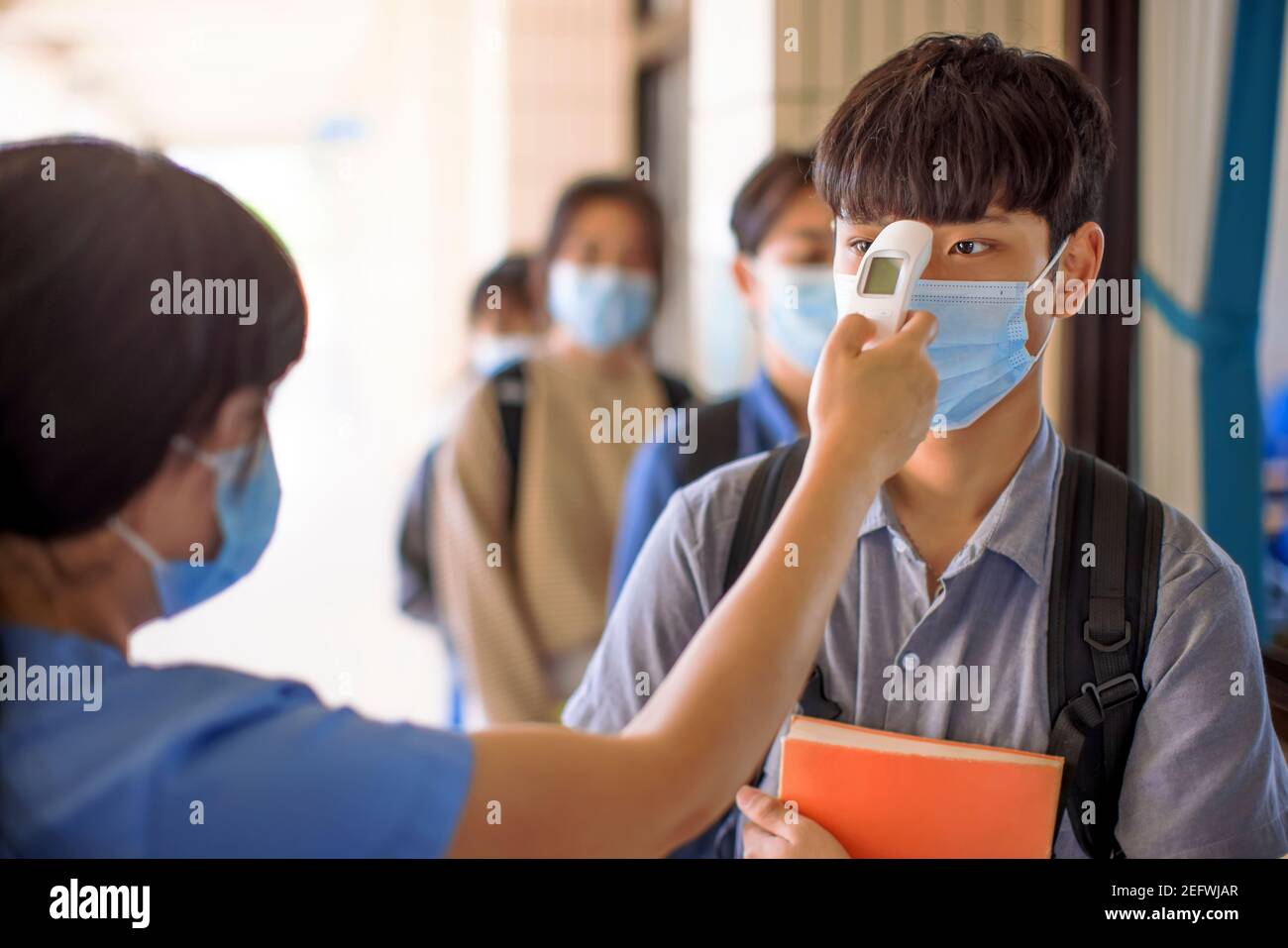 Measure Temperature and medical check at school for covid-19 Stock Photo