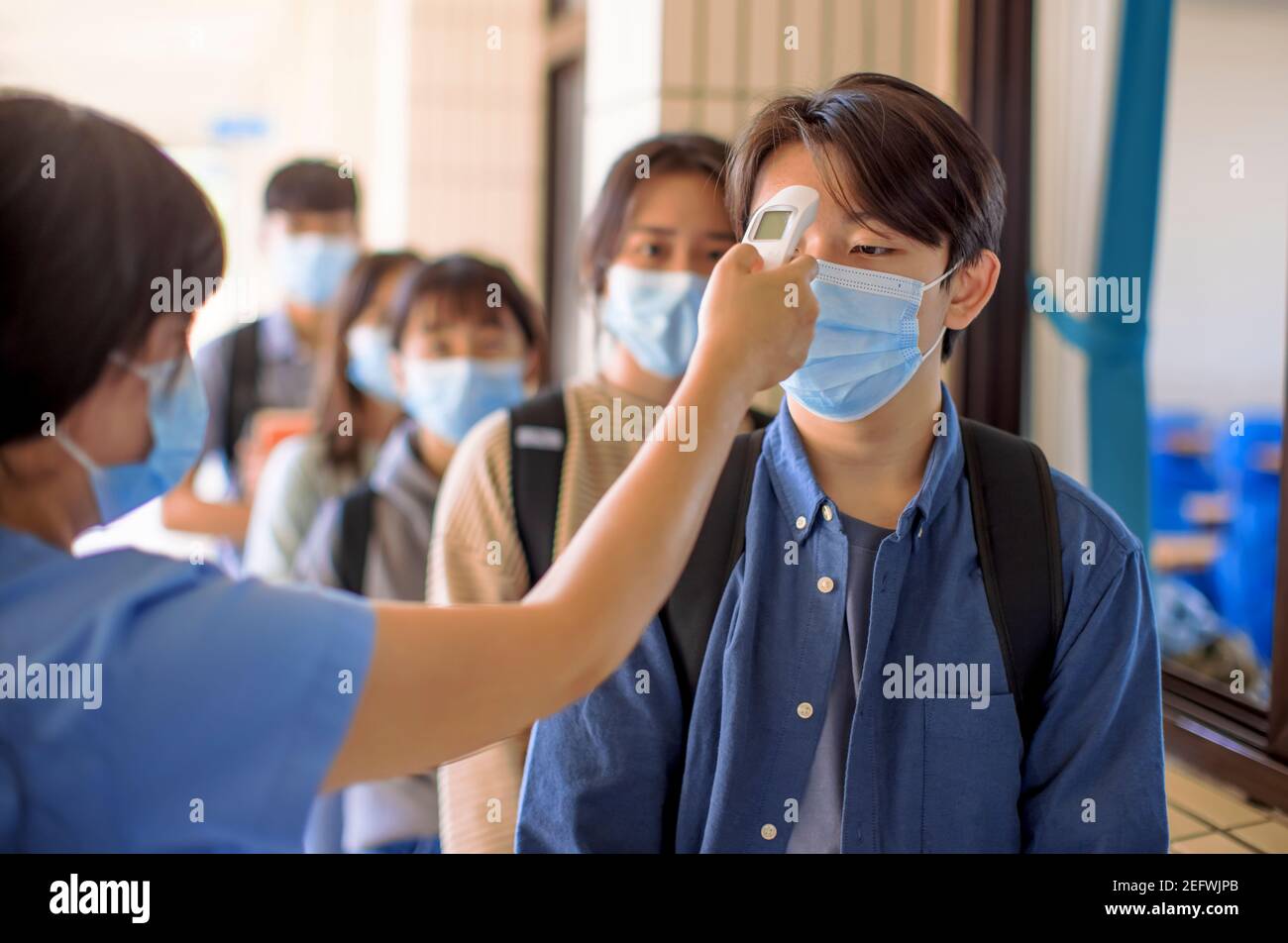 Measure Temperature and medical check at school for covid-19 Stock Photo